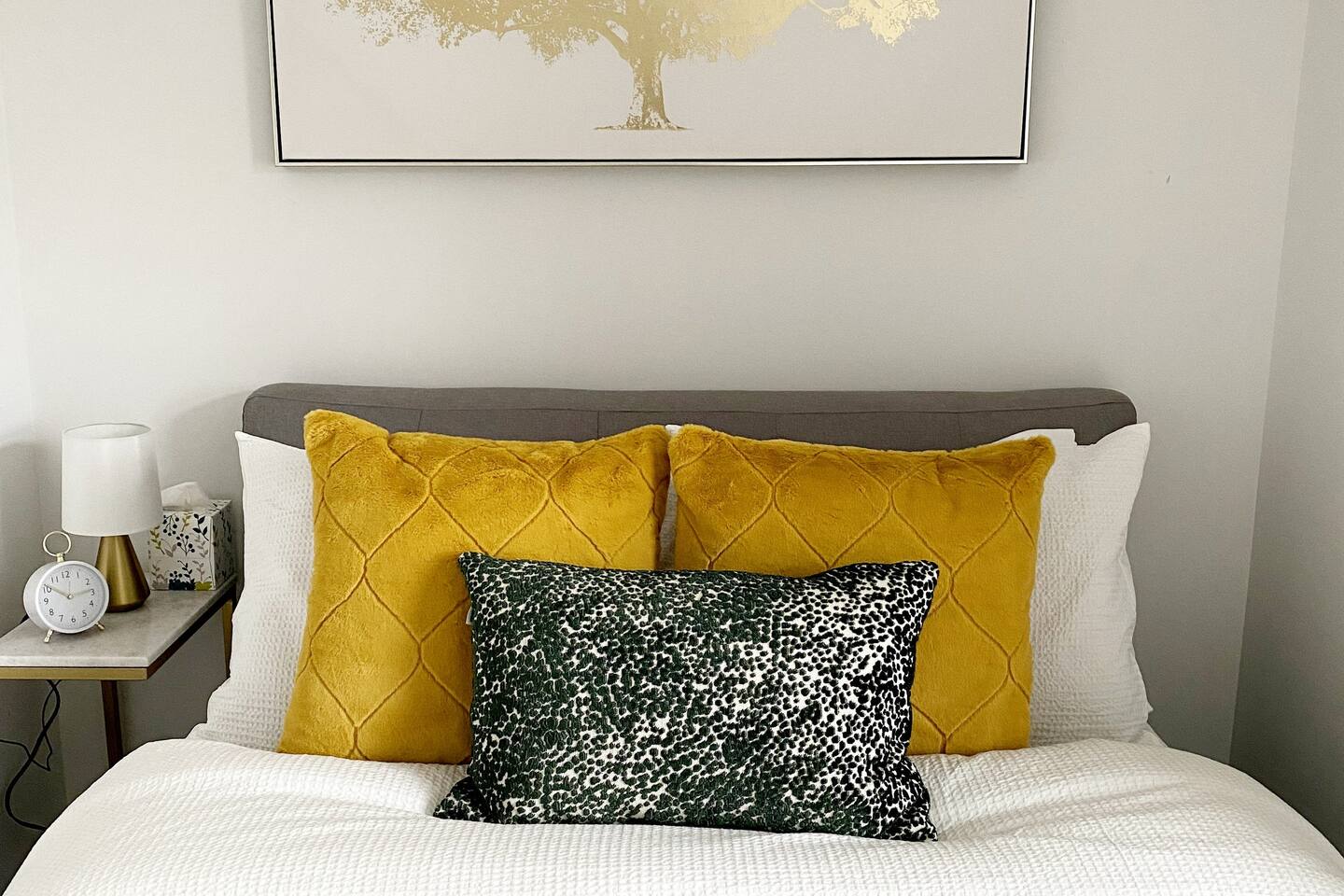 Close-up of layered pillows and soft bedding, adding a warm and comfortable touch to the bedroom.