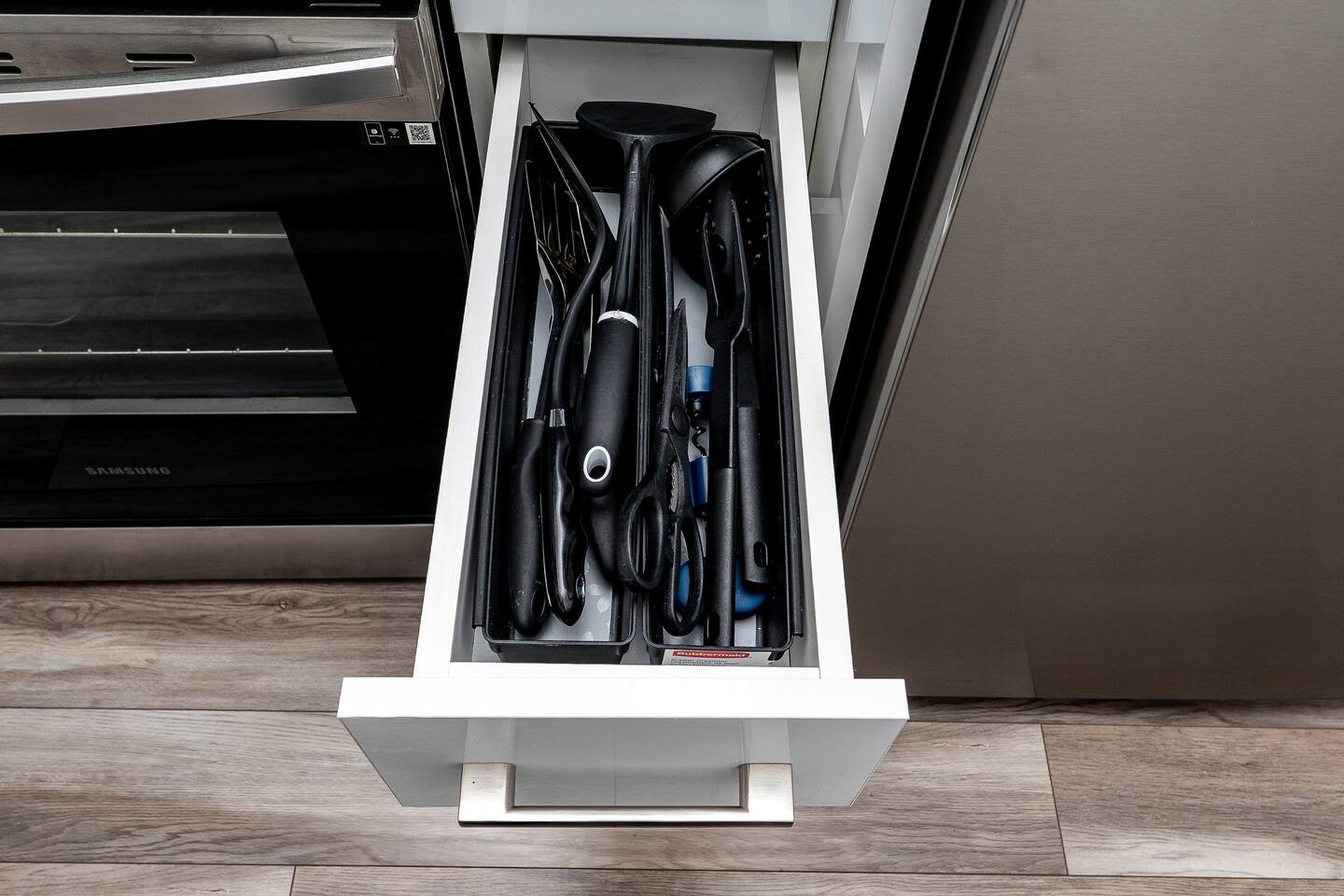 Kitchen drawer with neatly organized utensils and essentials, making meal prep and everyday dining more convenient during your stay.