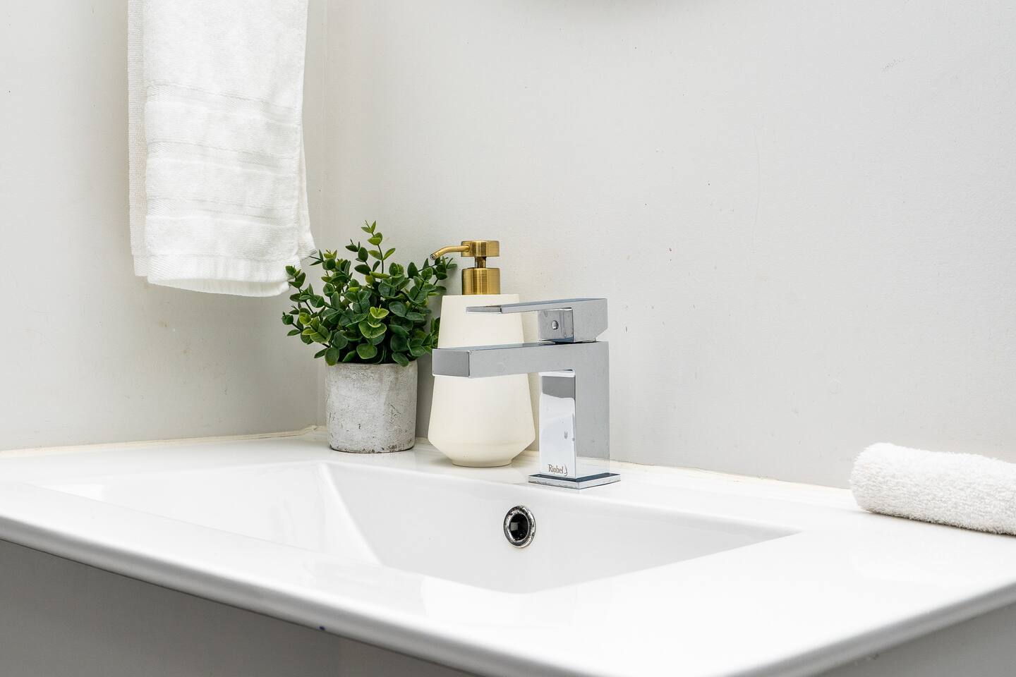Clean bathroom sink with a modern faucet, simple decor, and essentials for a fresh and easy daily routine.