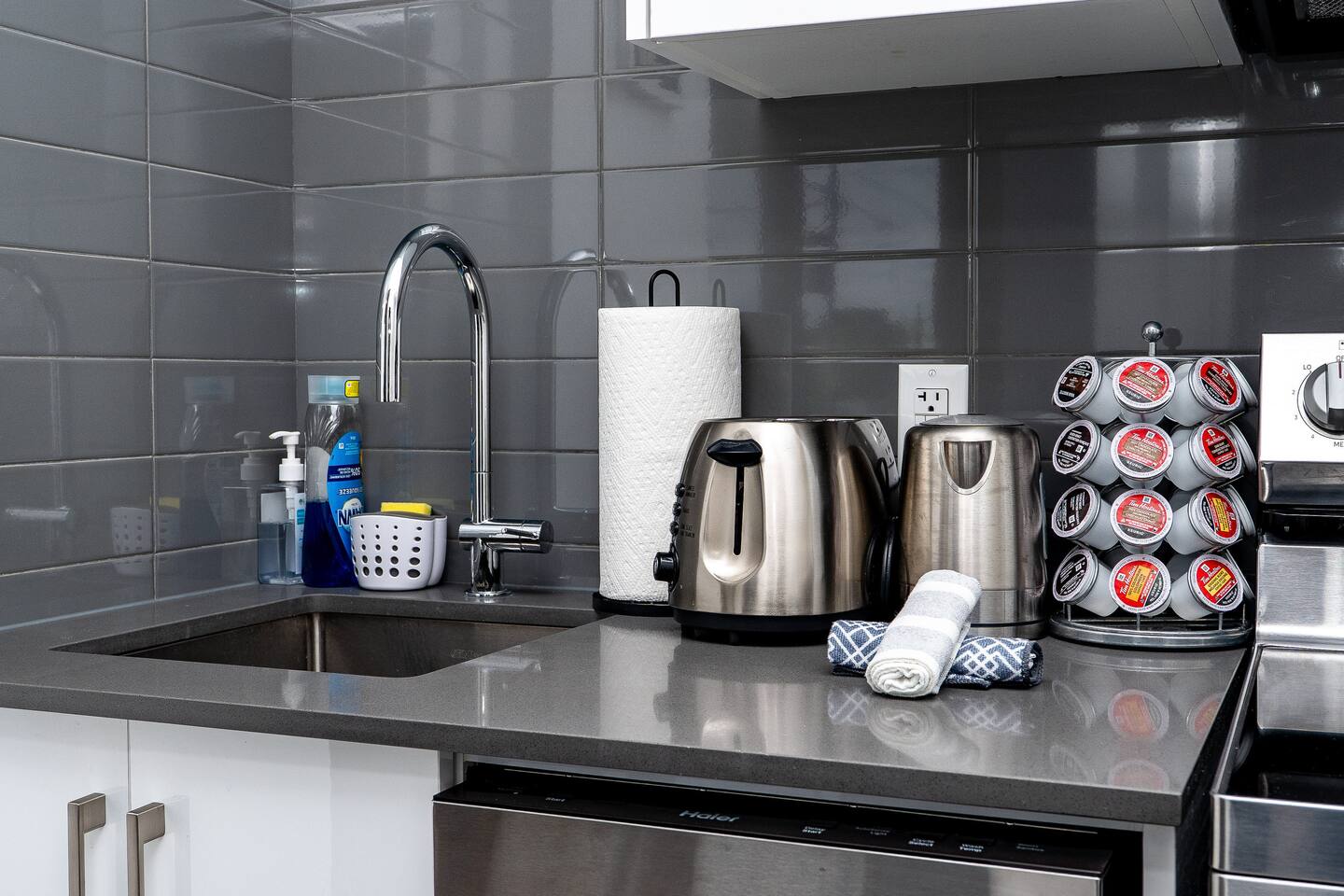 Compact kitchen counter with sink, kettle, and coffee setup, offering practical essentials for easy mornings and simple meals.