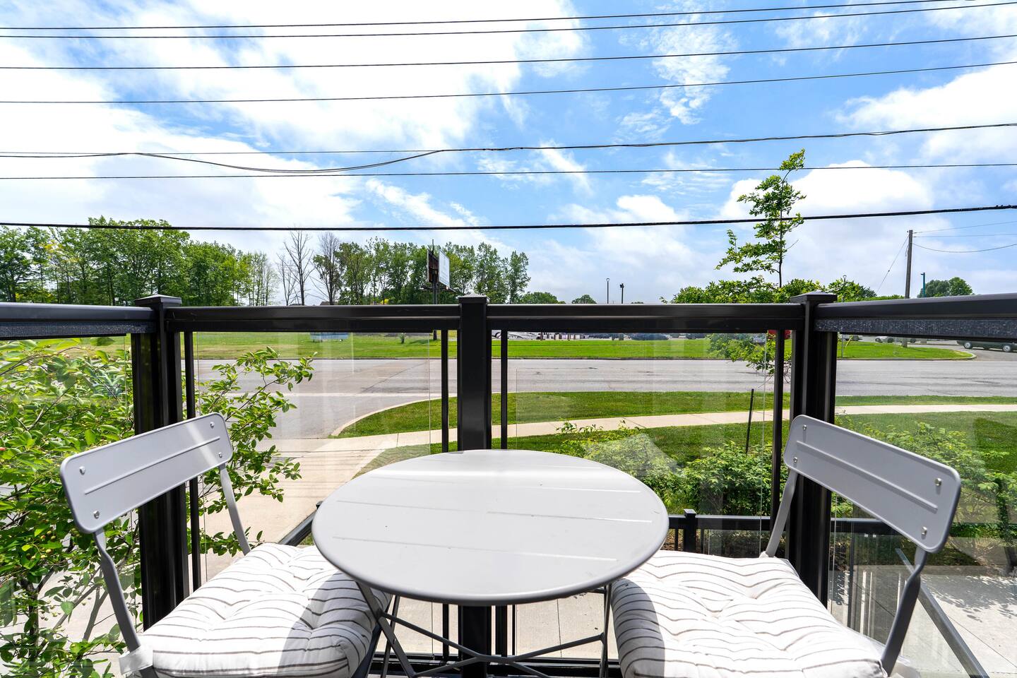 Private balcony with outdoor seating and open views, offering a calm spot to enjoy fresh air and natural light.
