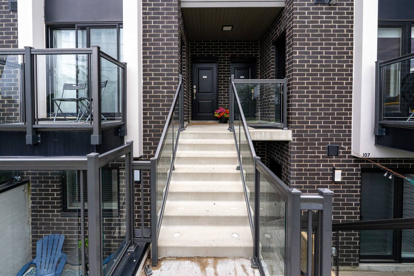 Covered exterior stairway leading to the private entrance, offering a clear and convenient arrival path to the home.