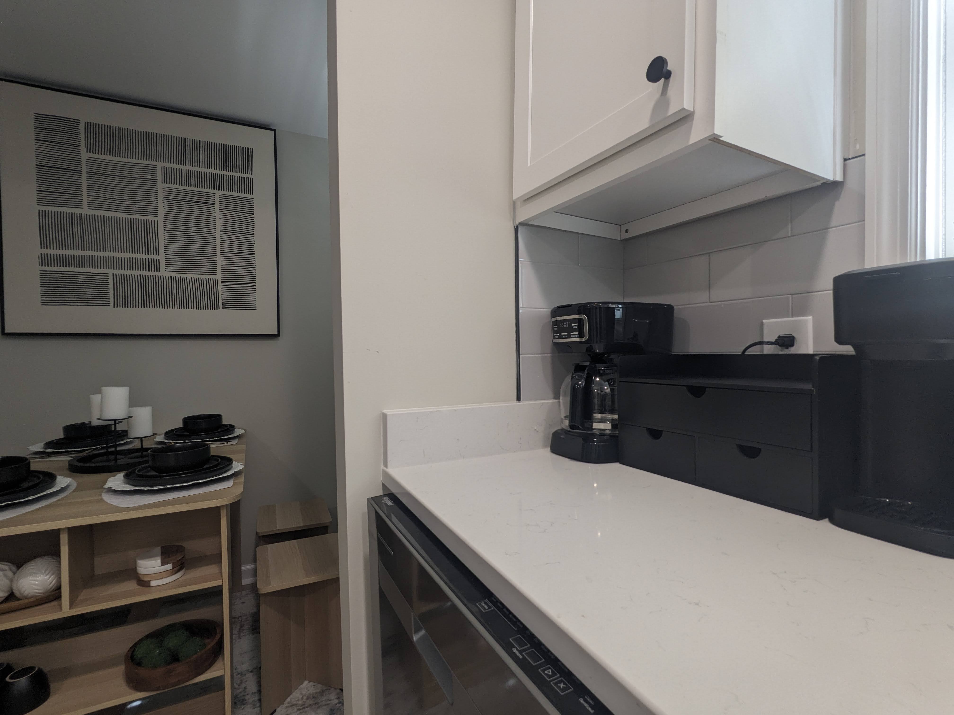 Modern kitchen nook with coffee station and cozy adjacent dining area