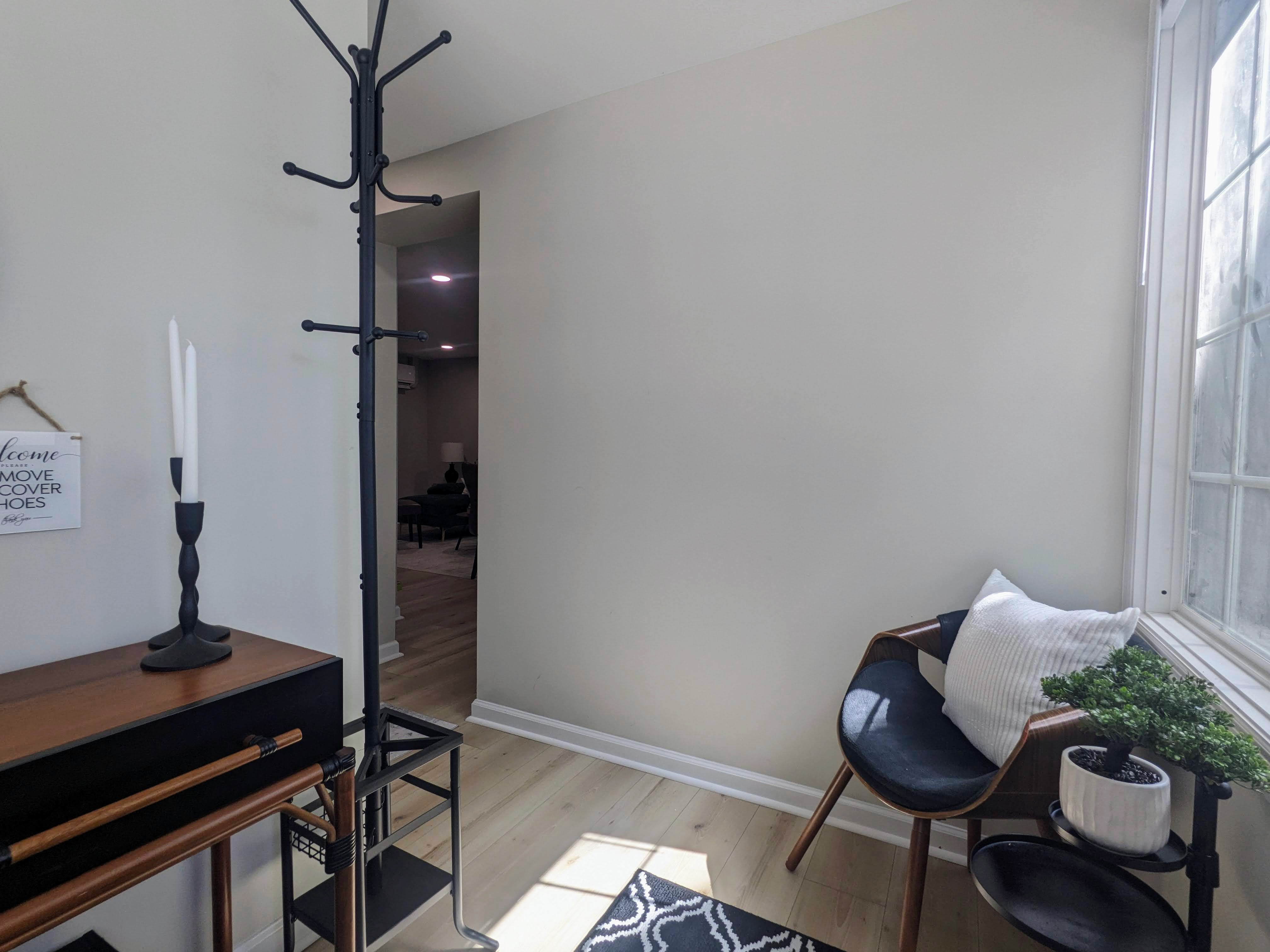 Bright, modern entryway with natural light and stylish seating
