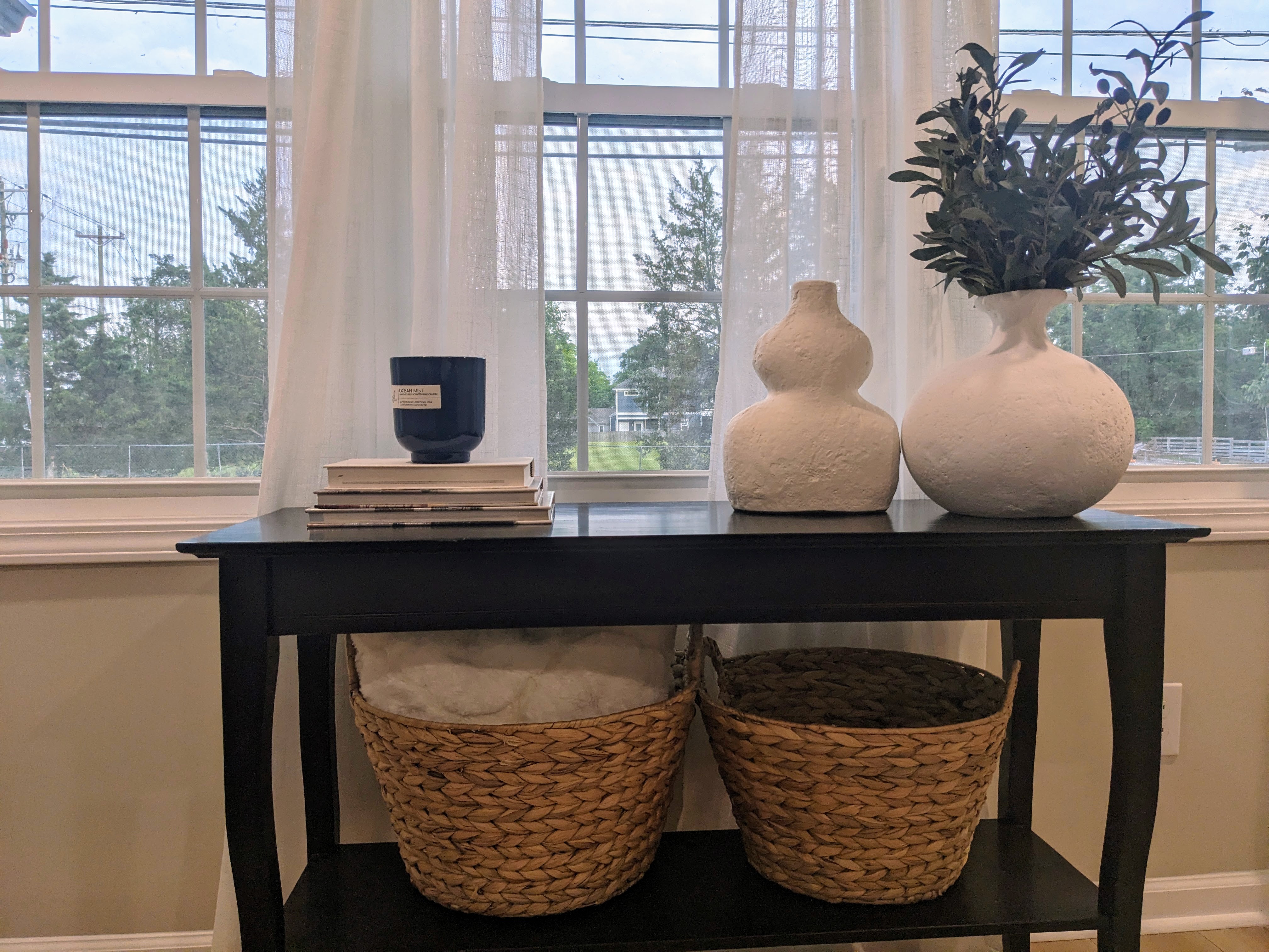 Bright, airy console nook with oversized windows and elegant decor
