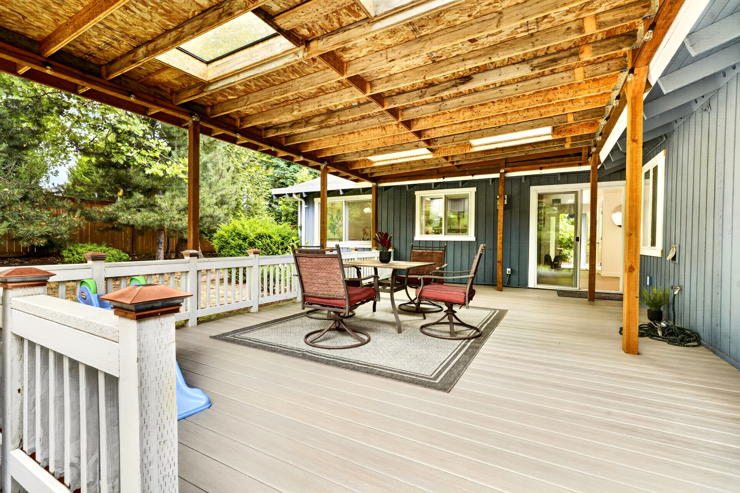 Spacious covered deck with skylights and cozy outdoor seating