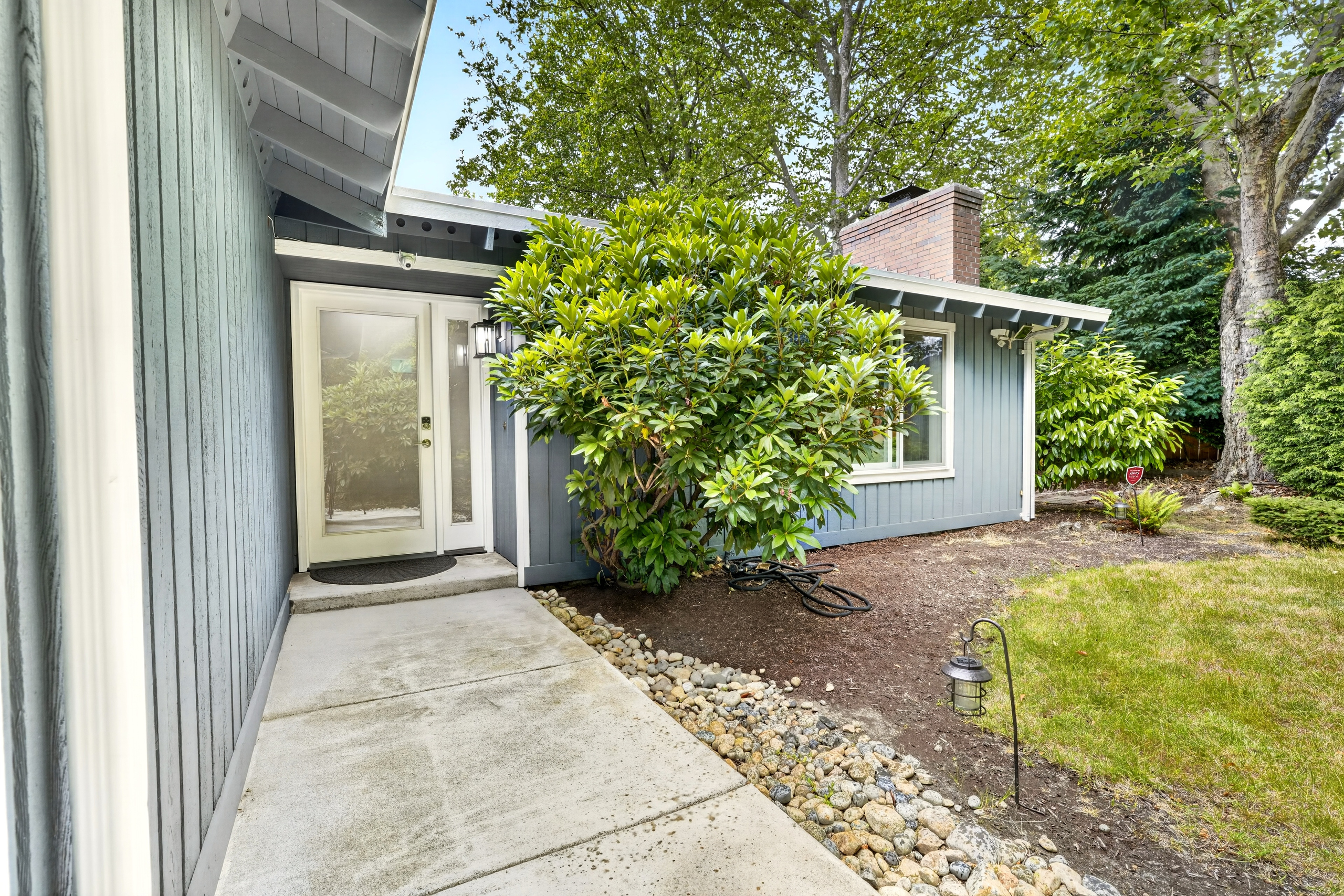 Inviting front entry with lush landscaping and great curb appeal