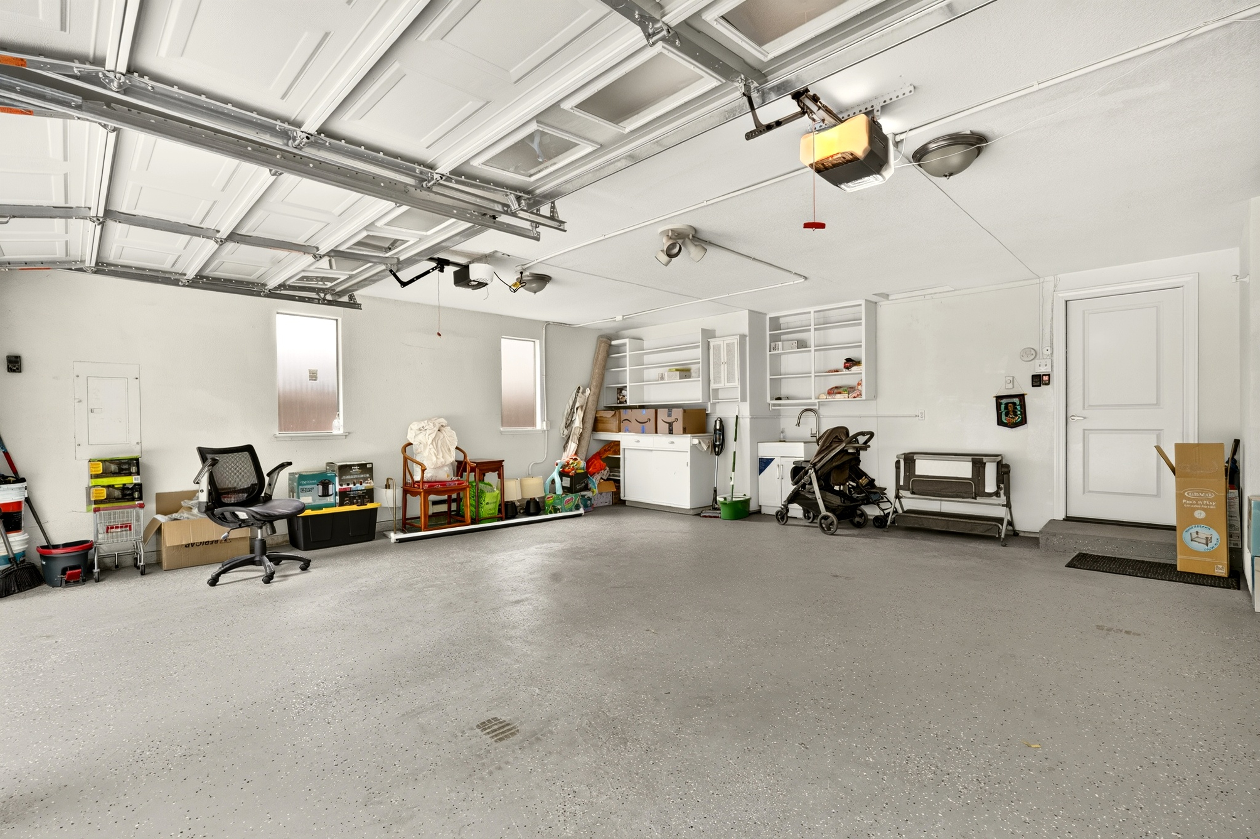 Spacious, clean garage with built-in storage and utility sink