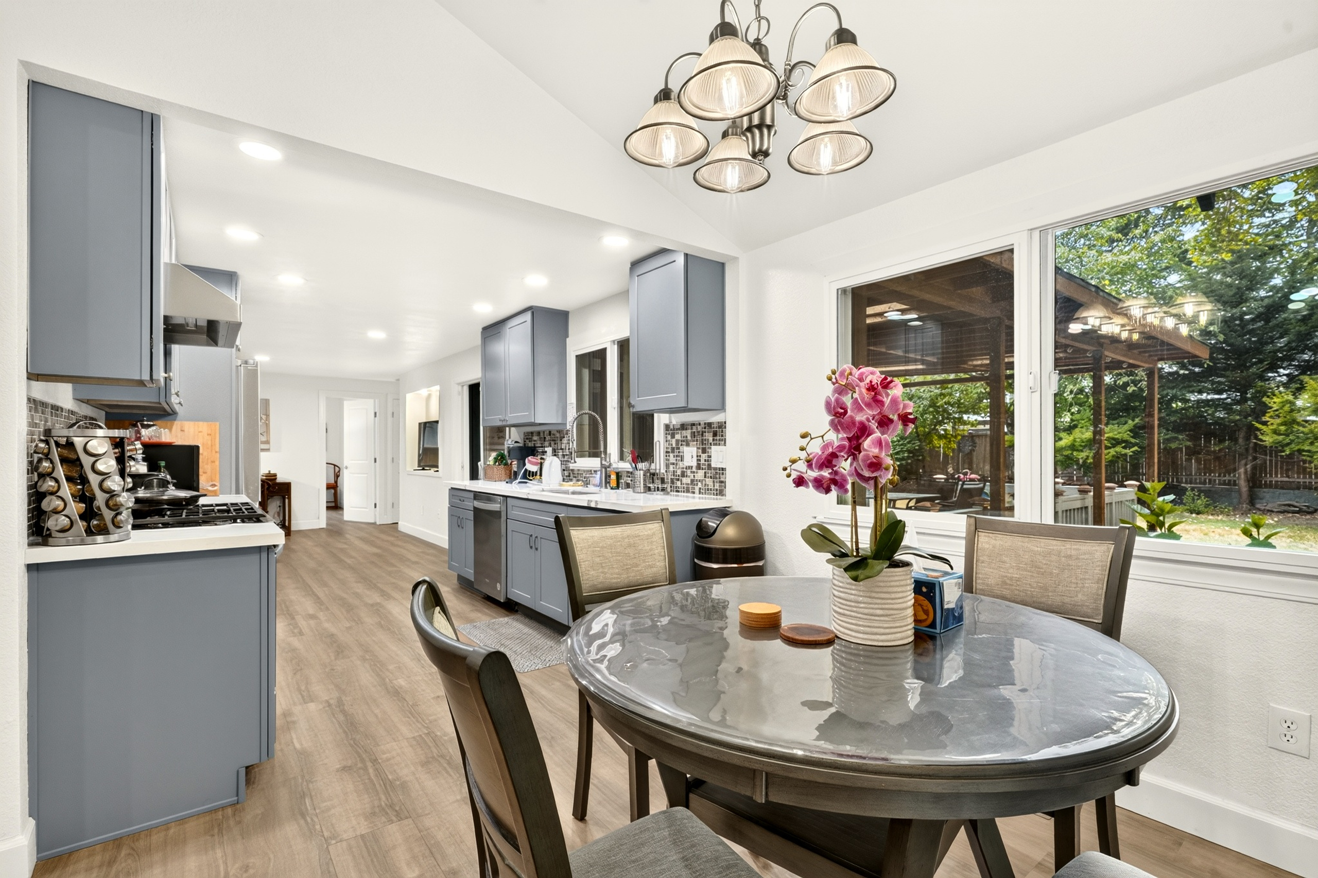 Bright modern kitchen and dining area with backyard views