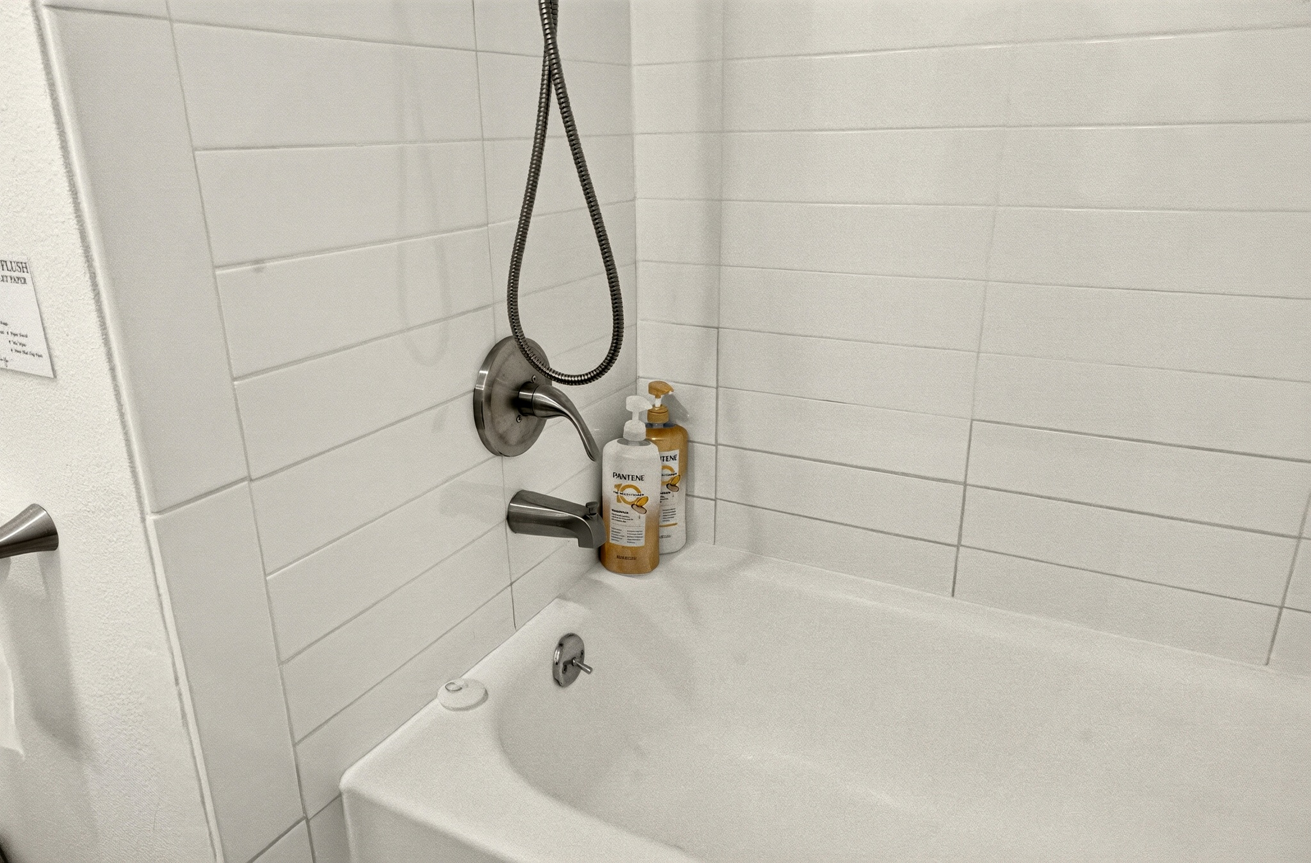 Bright tiled tub-shower combo with clean, modern guest-ready finishes