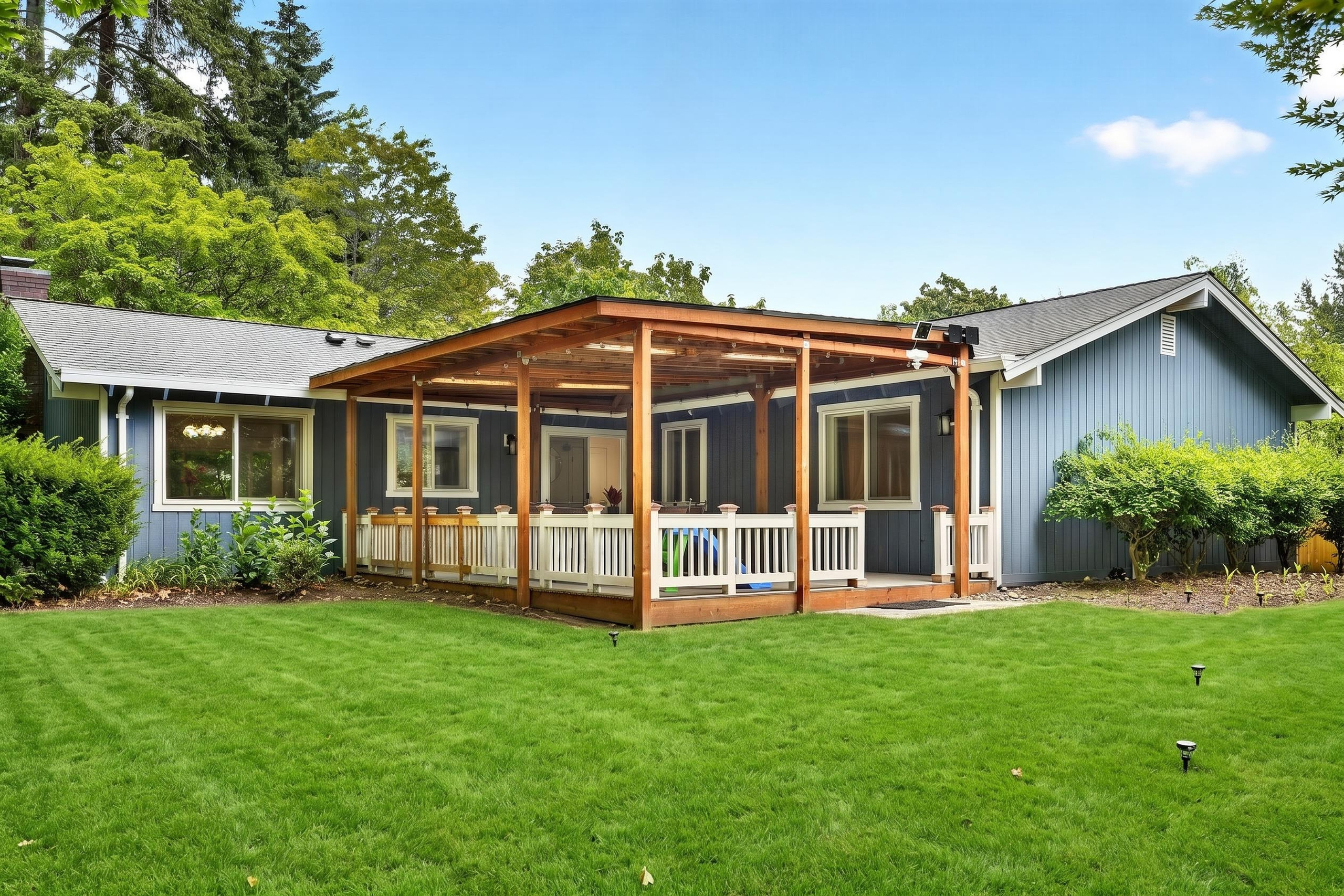 Spacious covered deck and lush private lawn for relaxing outdoor stays