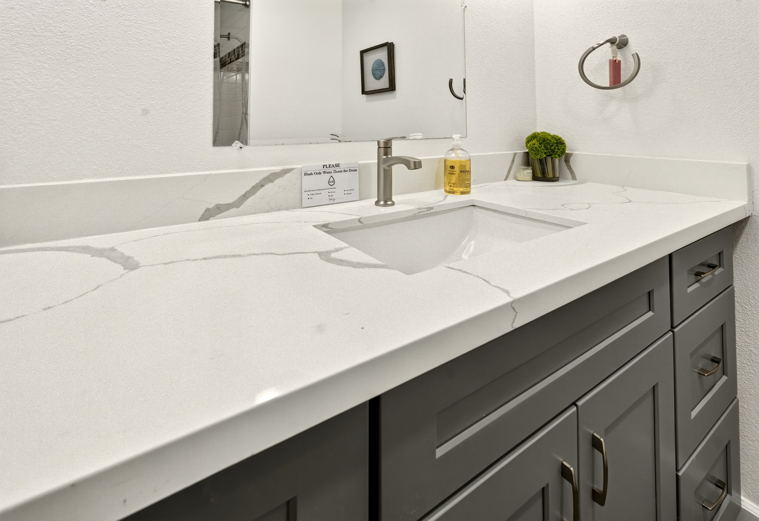 Modern bathroom vanity with quartz counters and stylish storage