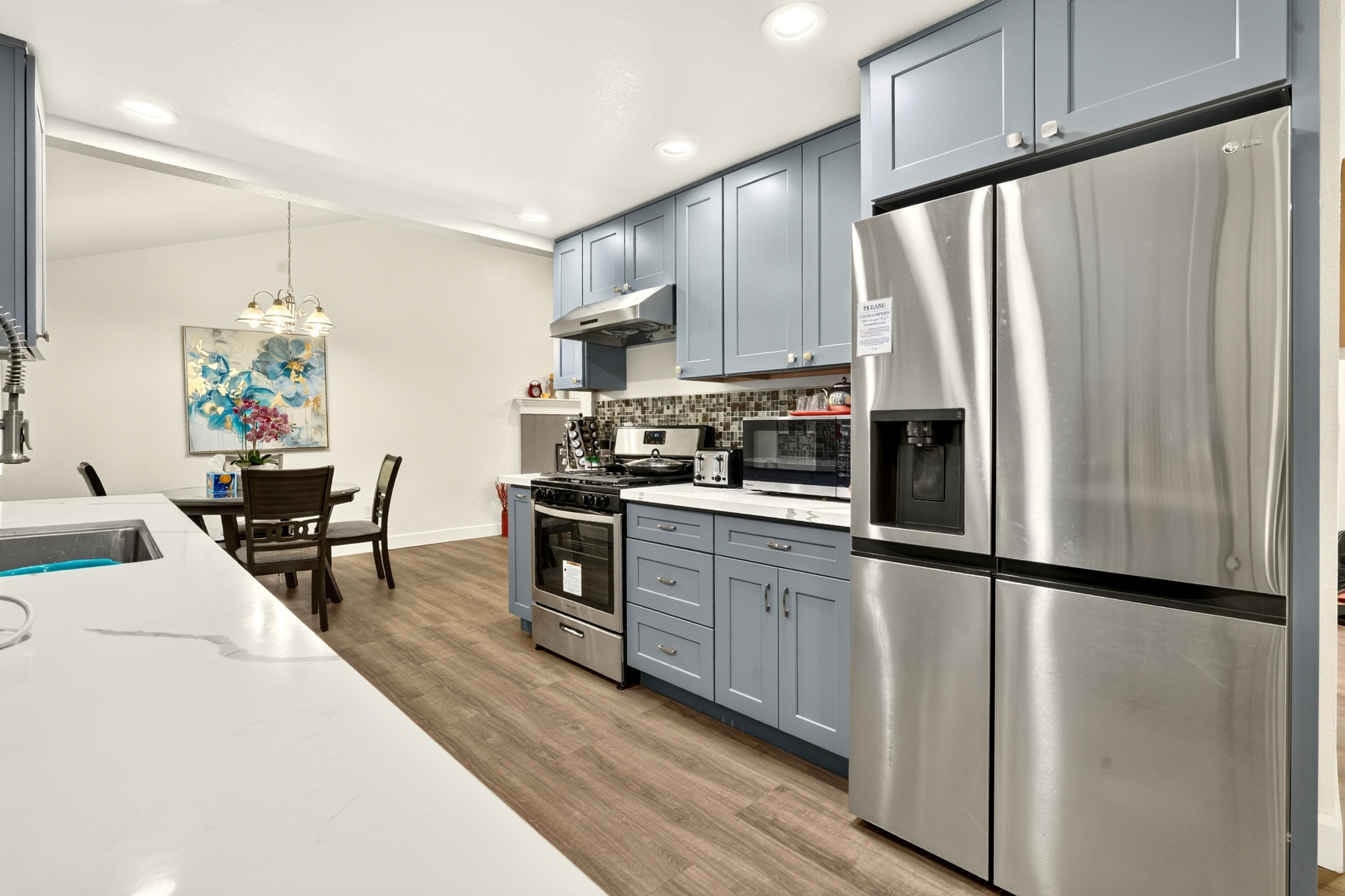 Bright modern kitchen with stainless appliances and dining nook