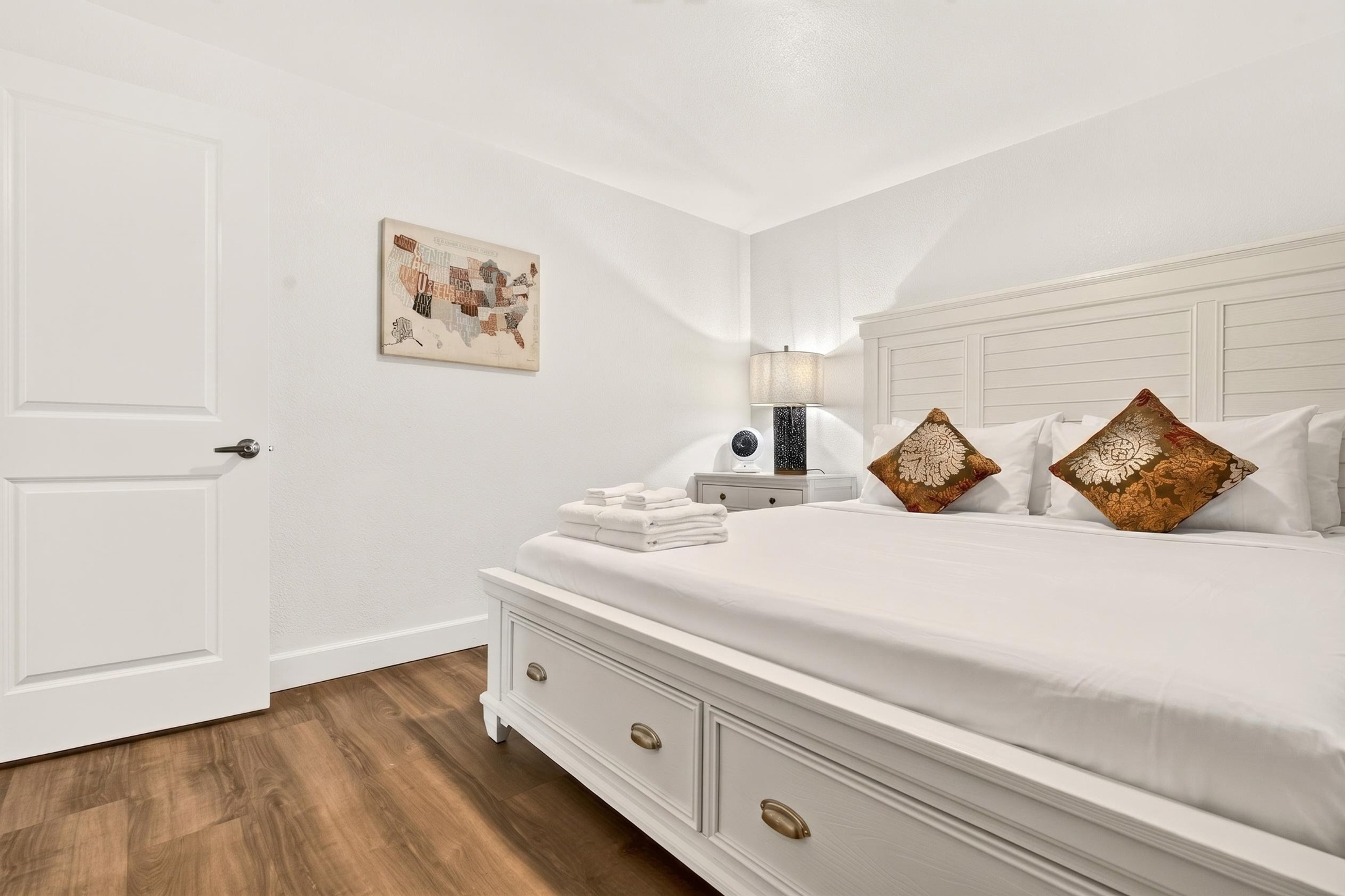 Bright, elegant bedroom with plush king bed and warm modern touches