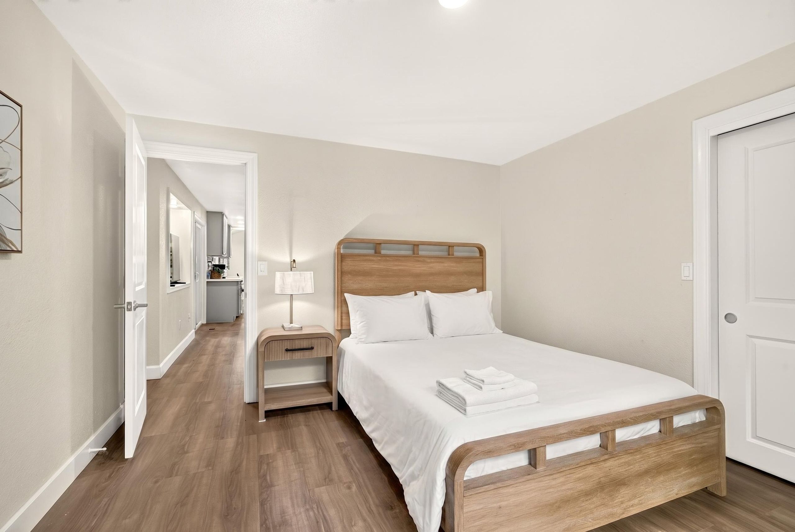 Bright, cozy bedroom with clean design and warm wood accents