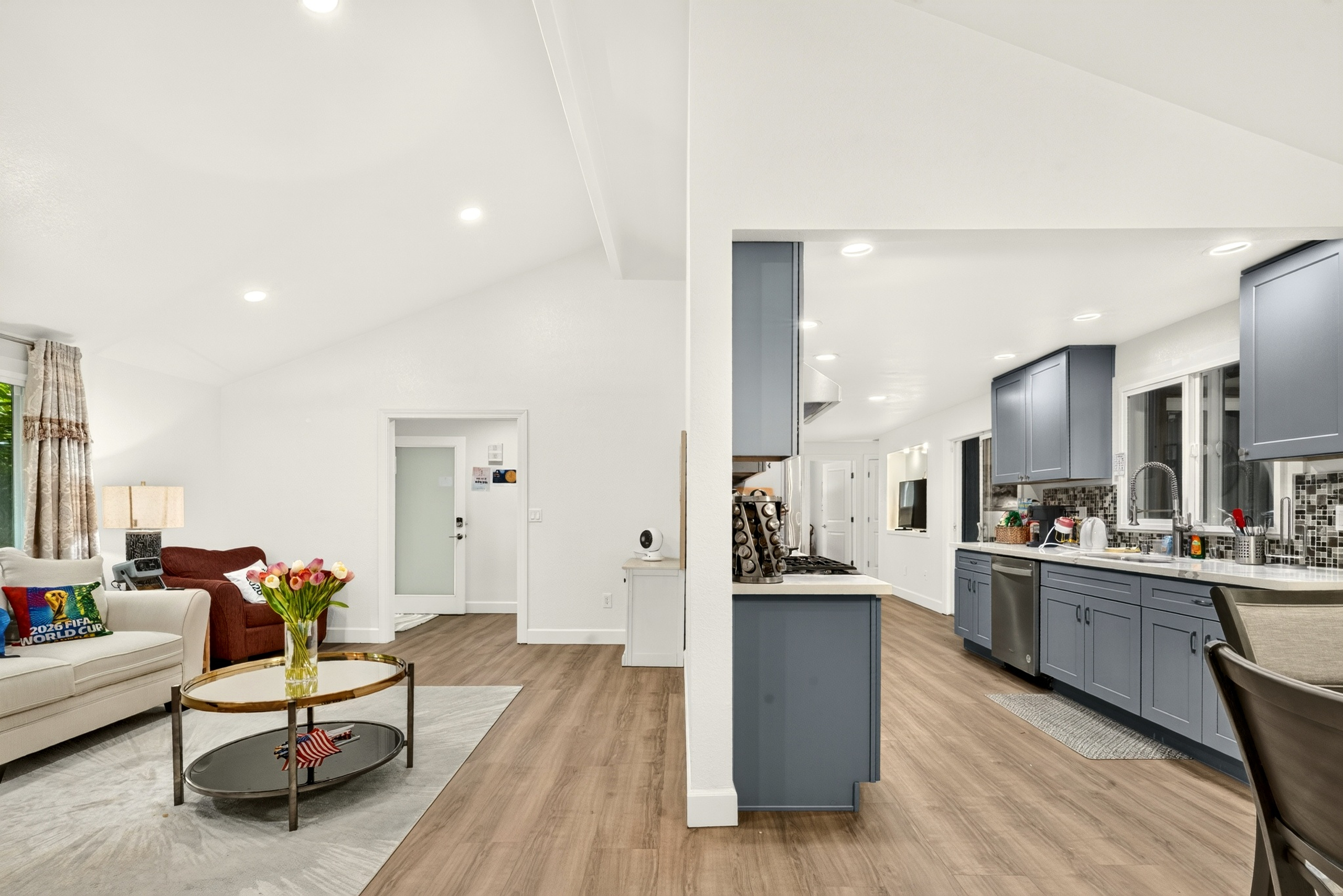 Bright open living space with modern kitchen and vaulted ceilings