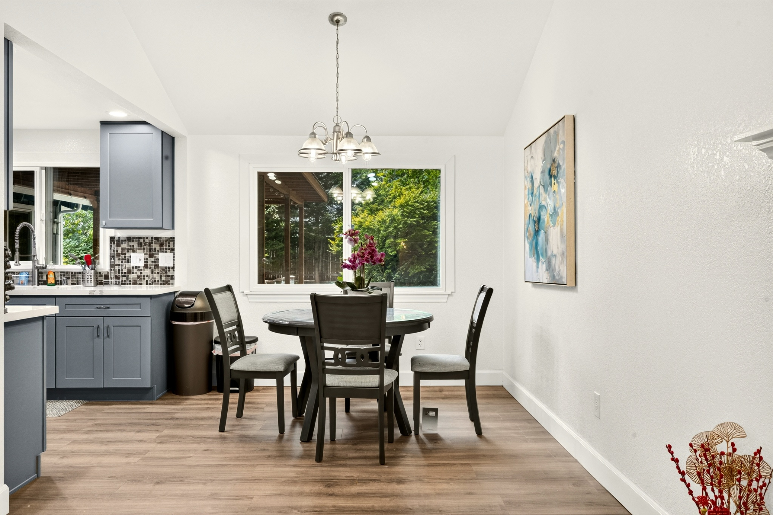 Bright dining nook with garden views and stylish modern kitchen nearby