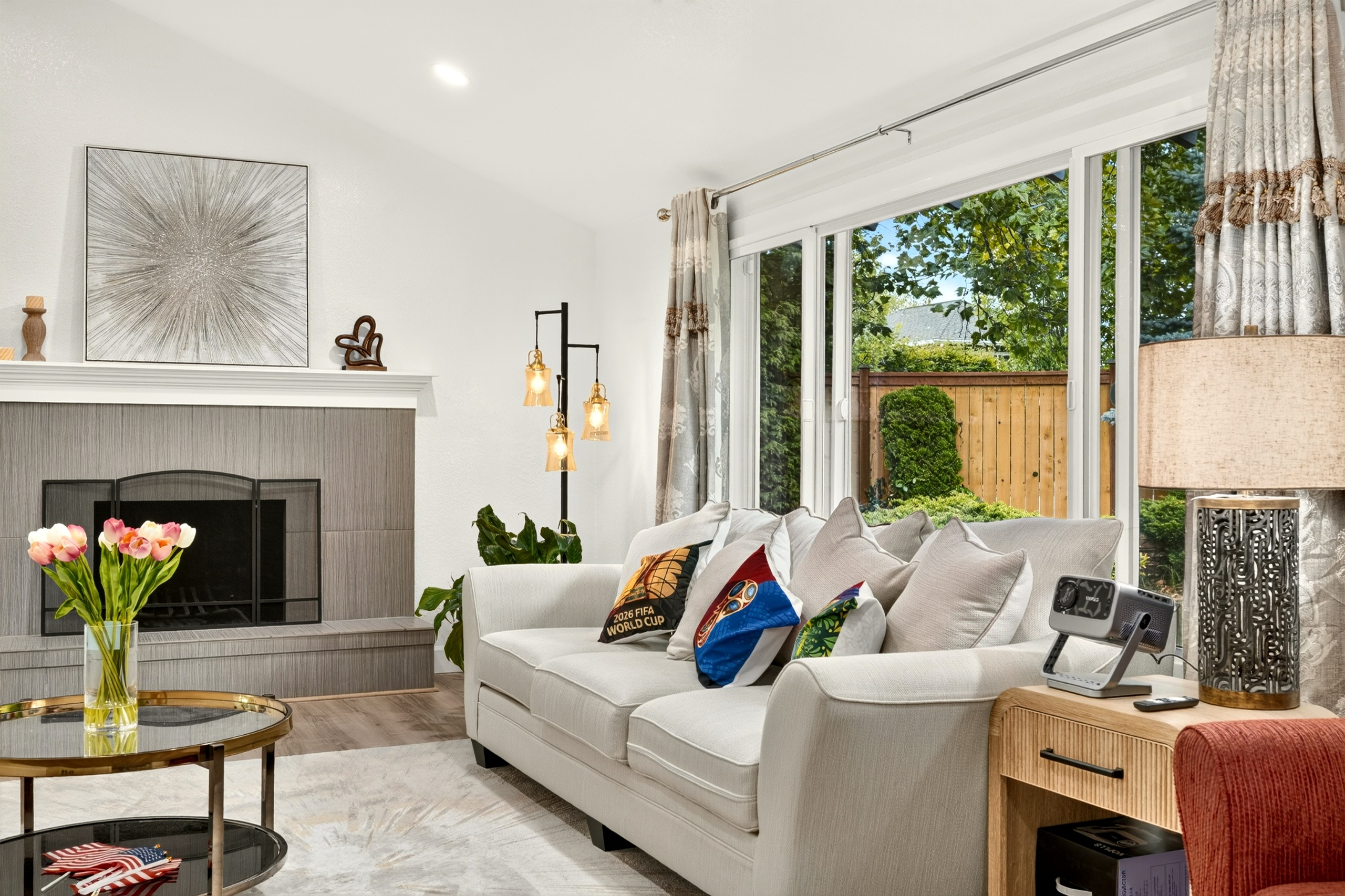 Bright cozy living room with fireplace and garden-view patio doors