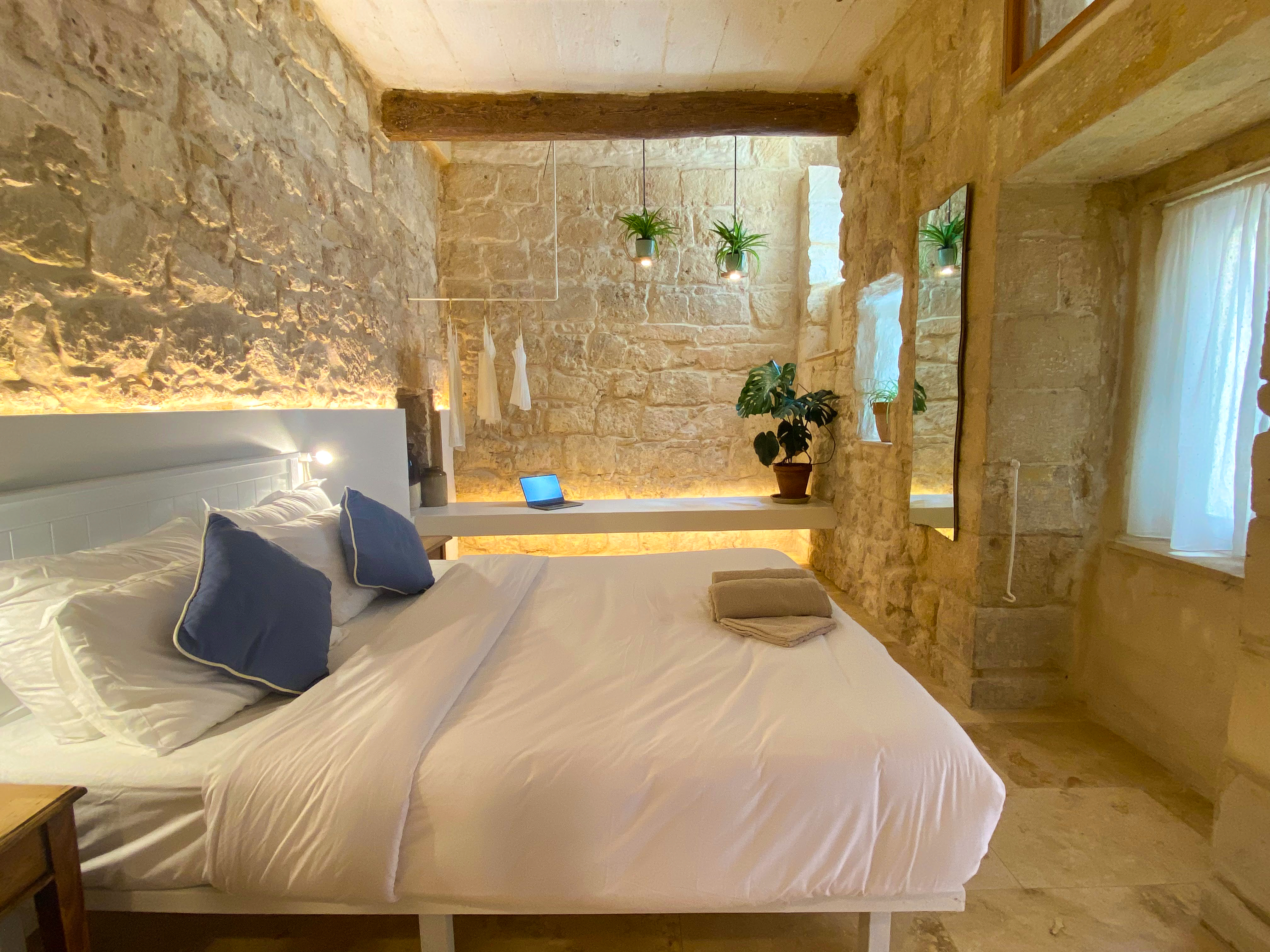 Charming stone-walled bedroom with warm lighting and rustic elegance