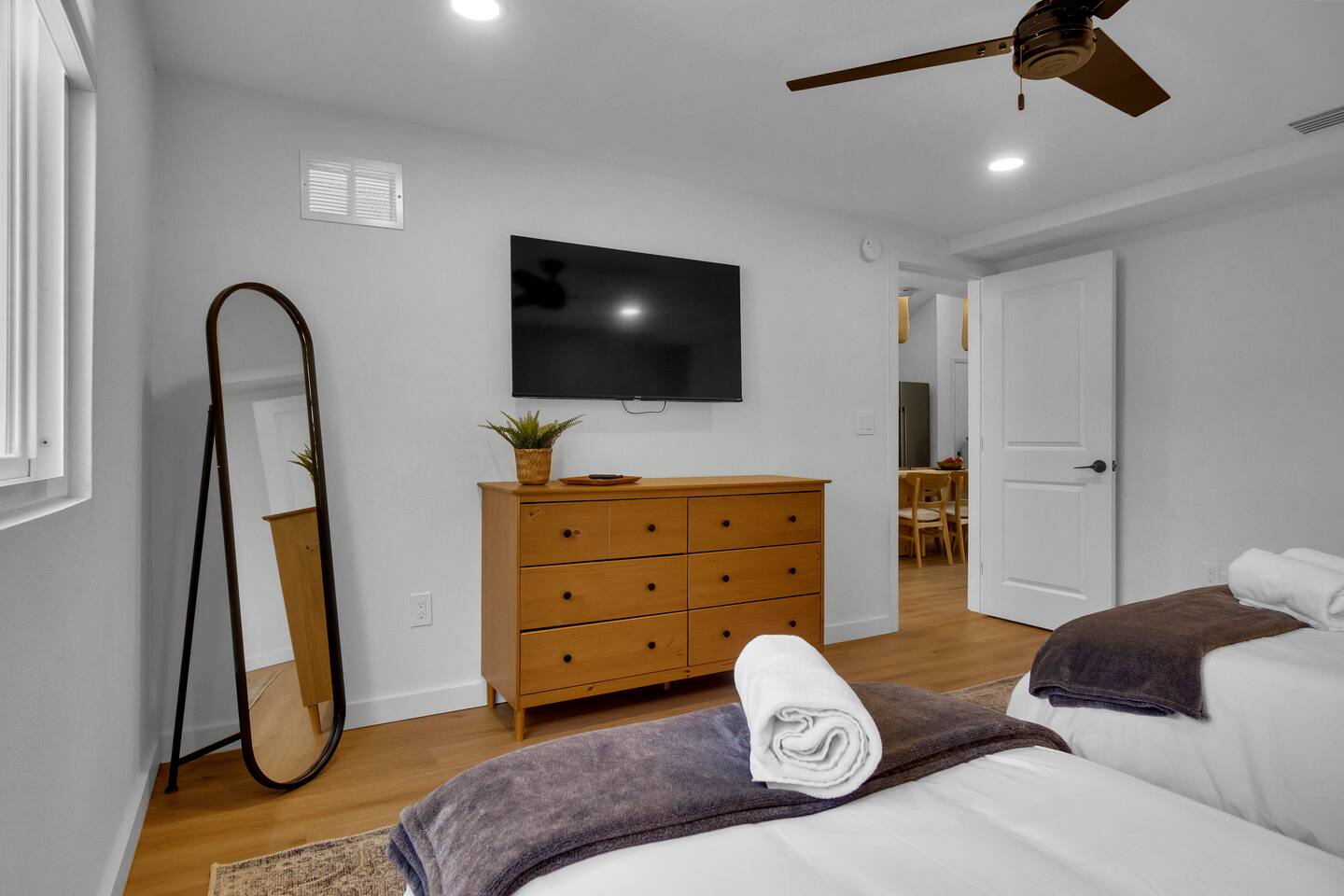 Bedroom 1 with floor length mirror, plenty of drawer space and closet for clothes.  Luggage racks provided & smart TV