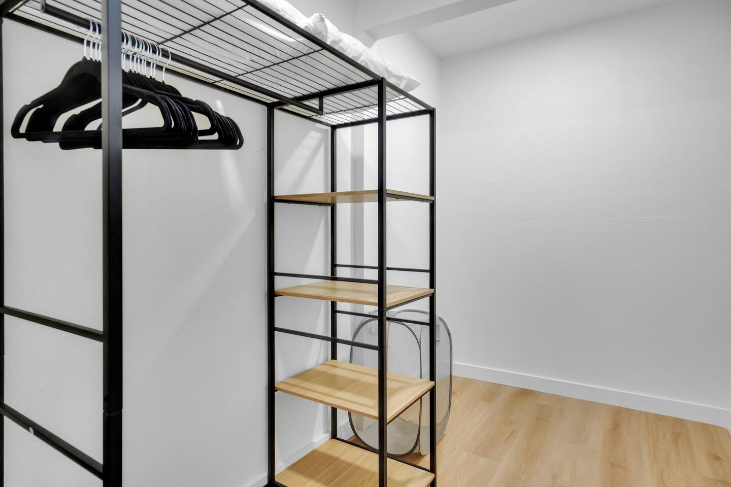 Master closet with plenty of room for clothes , extra pillows , luggage with luggage rack and hamper, iron and iron board