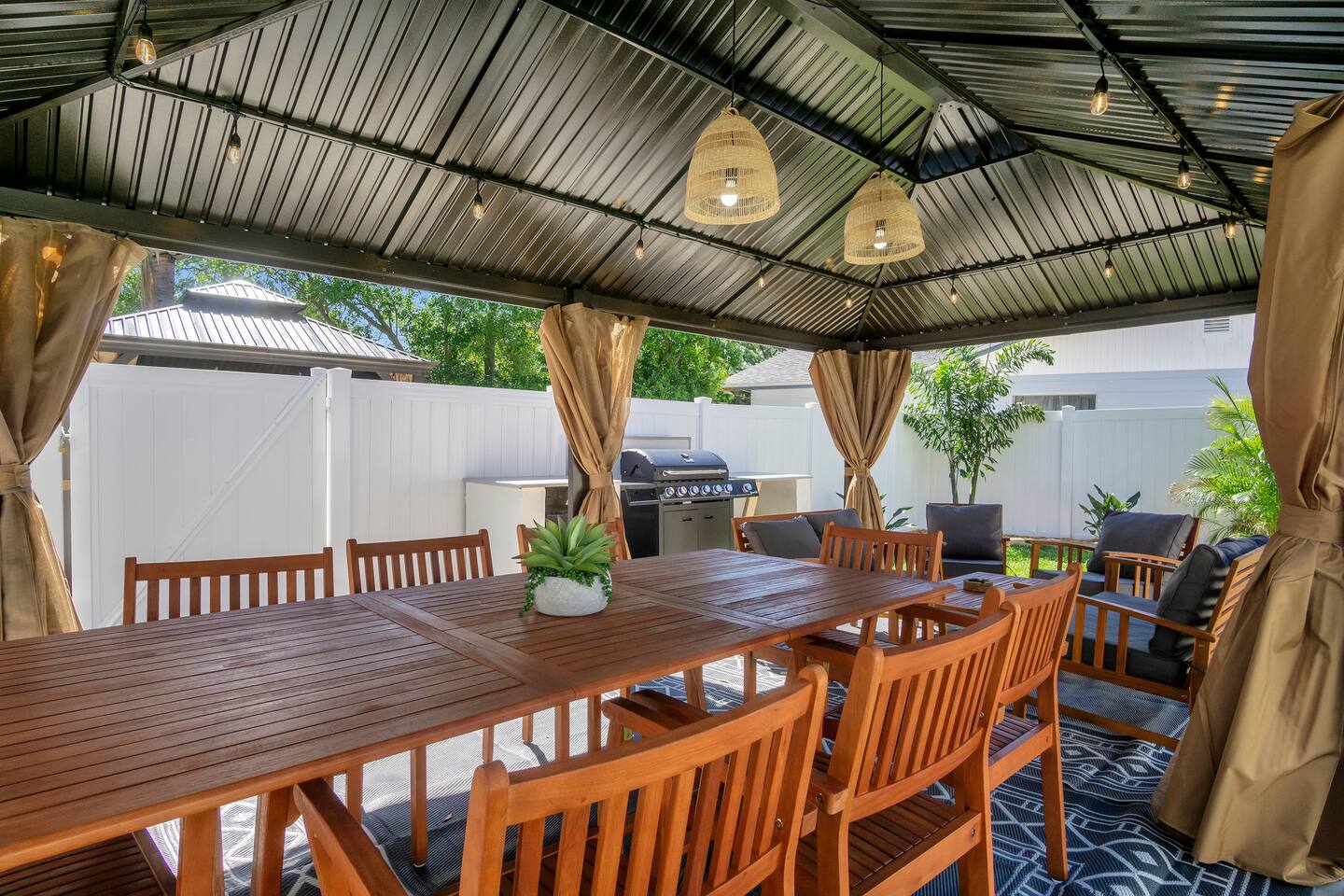 Large covered backyard area perfect for entertaining and bbq with gas grill.
