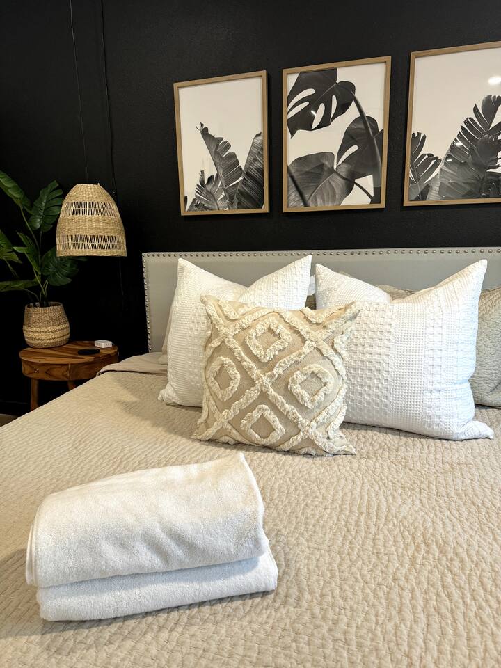 Master king bedroom with lots of pillows, large walk in closet and bedside night lights with charging stations .