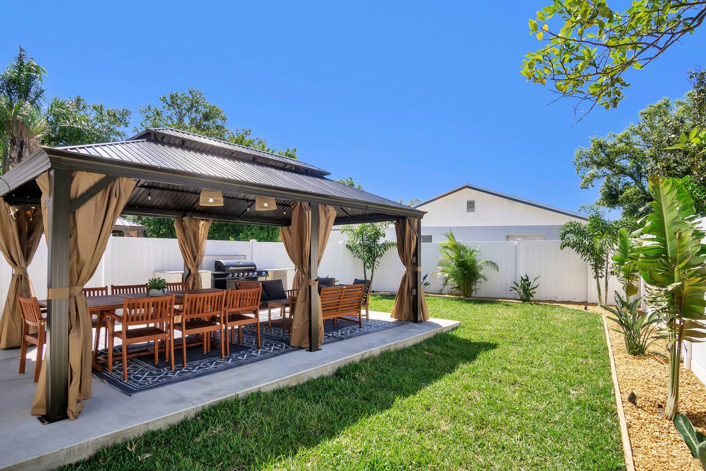 Enjoy the backyard with plenty of space, BBQ and corn hole provided.
