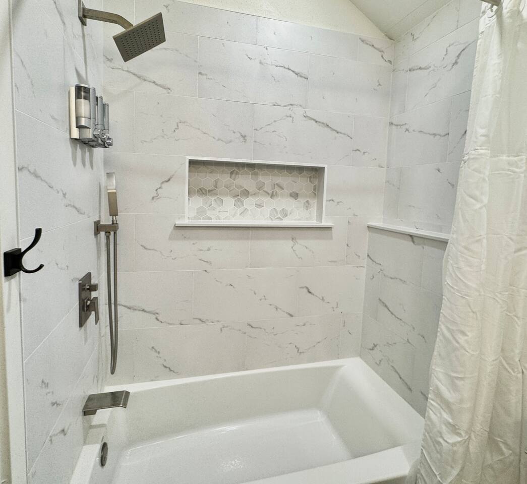 Downstairs full bathroom with tub and shower.   Bathroom for guests in bedroom 2