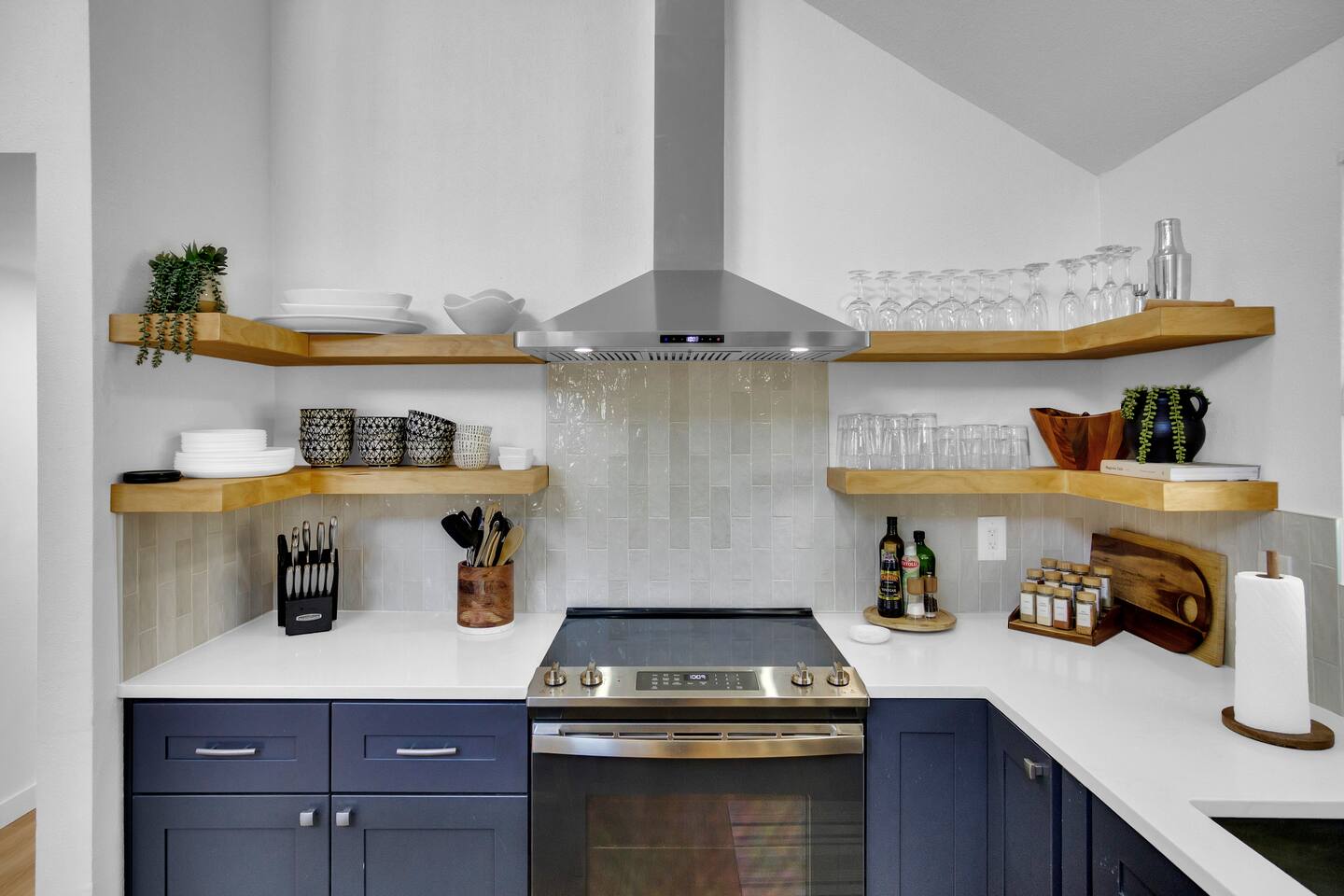 Kitchen with open shelving and plenty of dishes, serving platters, and glasses for every occasion.