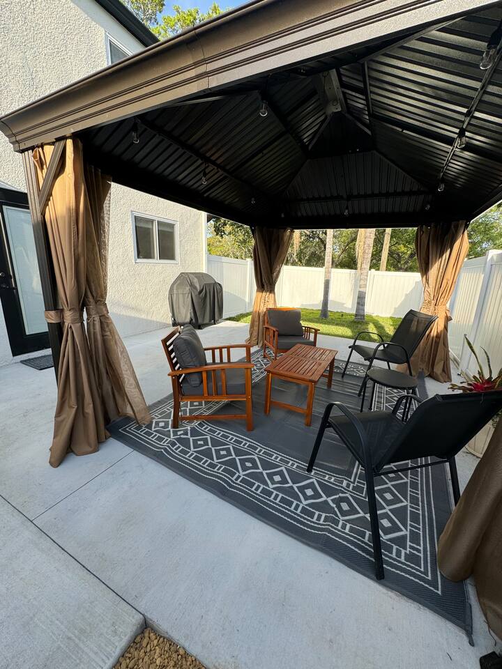 Cozy outdoor patio with BBQ, mosquito nets & curtains to keep bugs out in evenings.