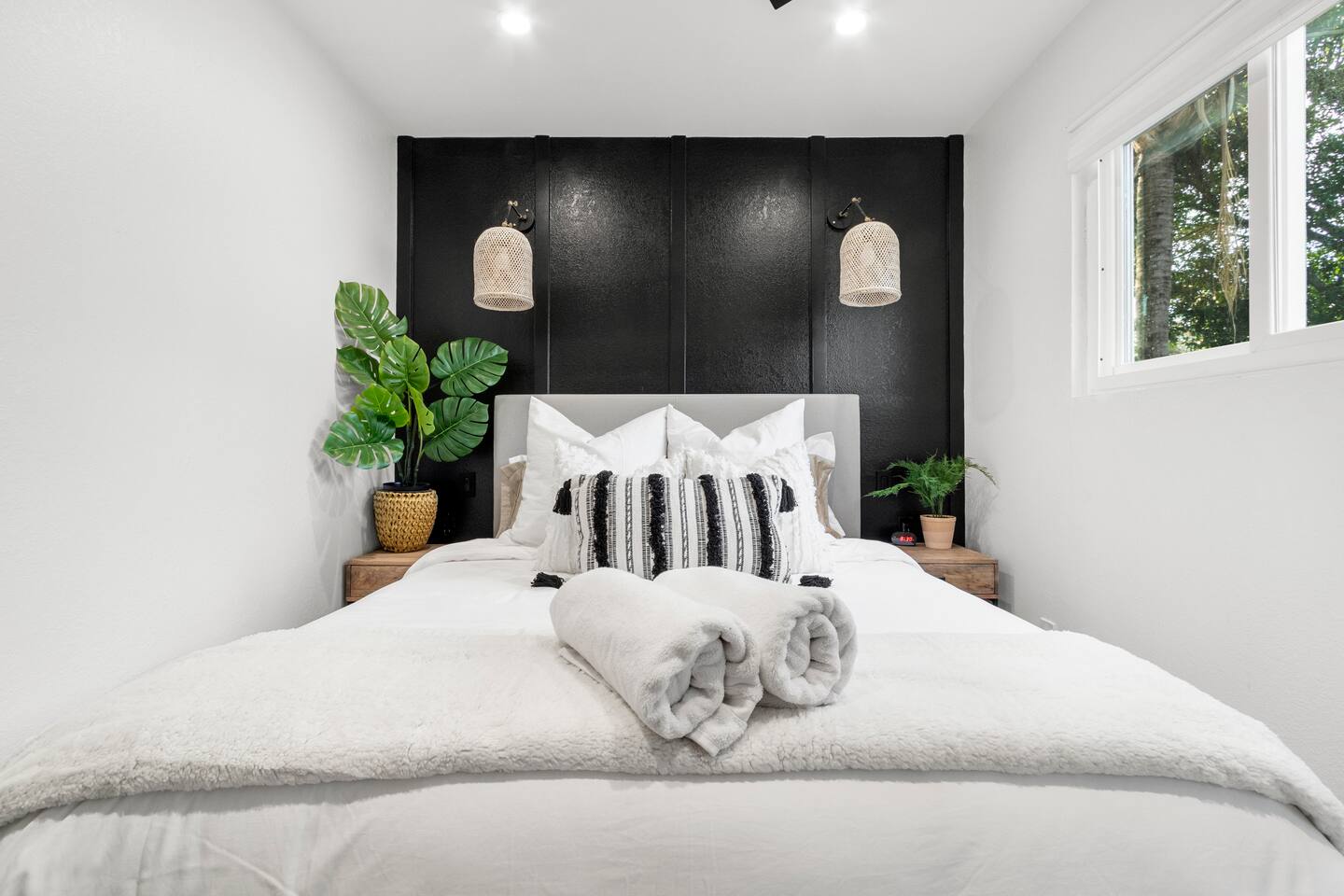Queen bed with reading lights and charging bedside charging station.