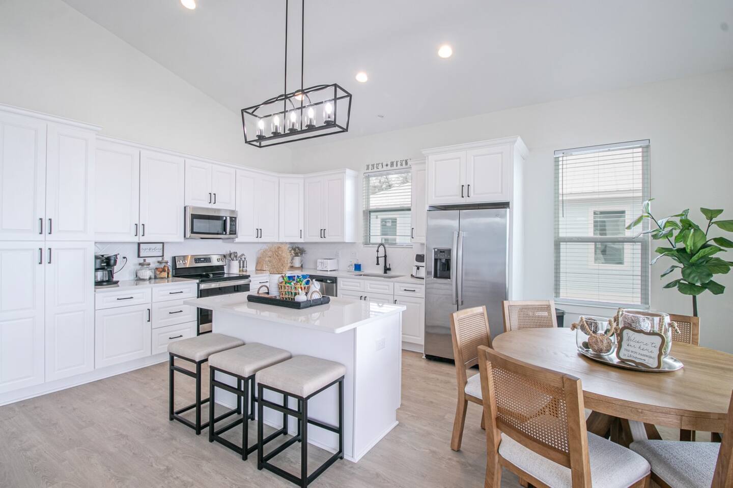White Breeze kitchen with island seating and dining table