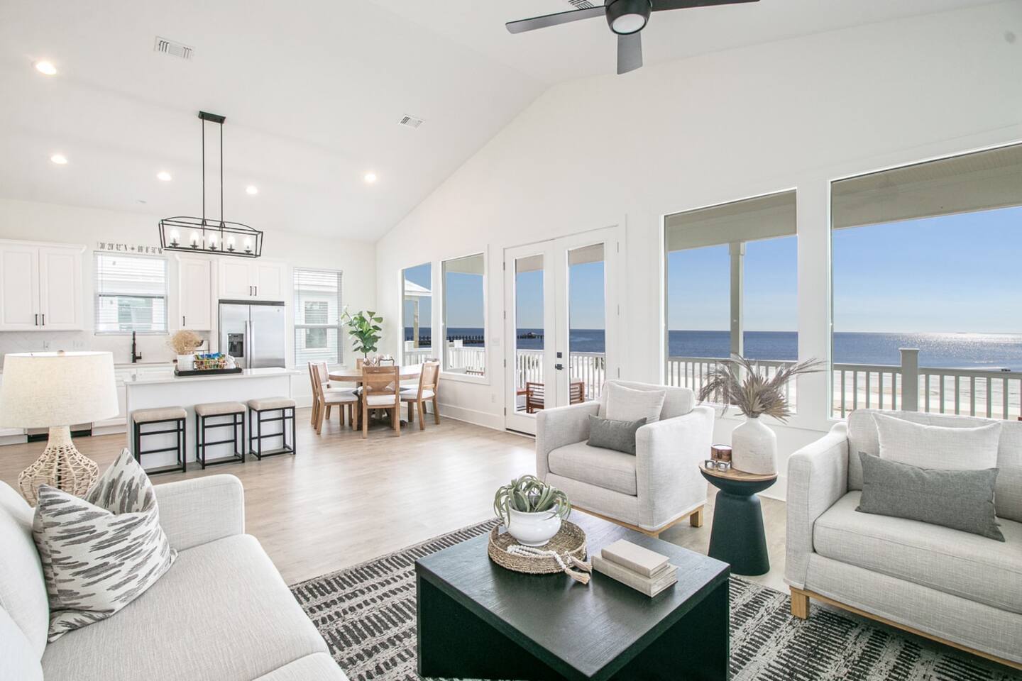 White Breeze open living room and kitchen with a wall of windows facing the Gulf