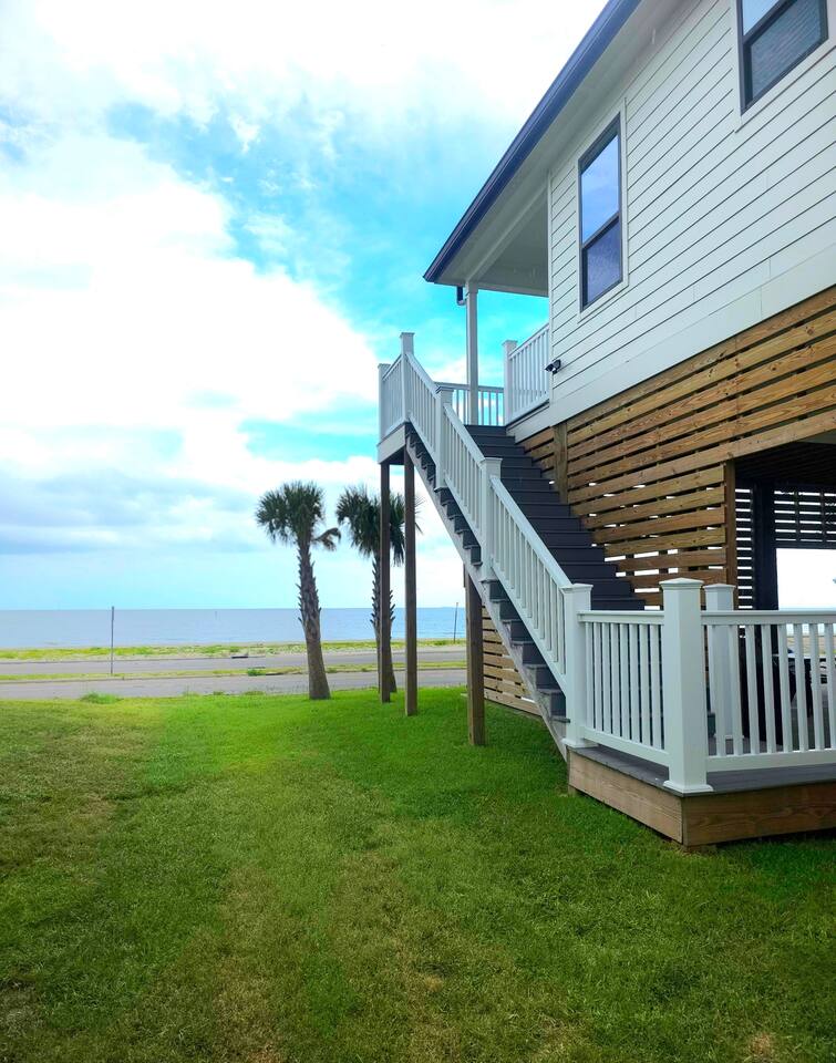 White Breeze back stairs with palm trees and the Gulf beyond