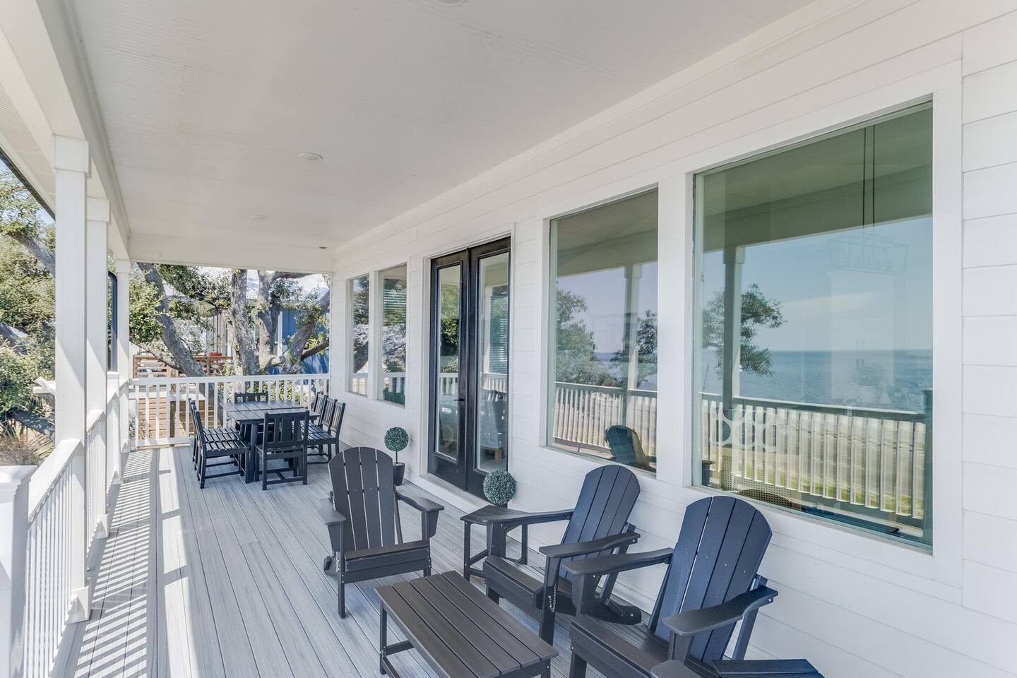 White Breeze front balcony with Adirondack chairs and a view of the water