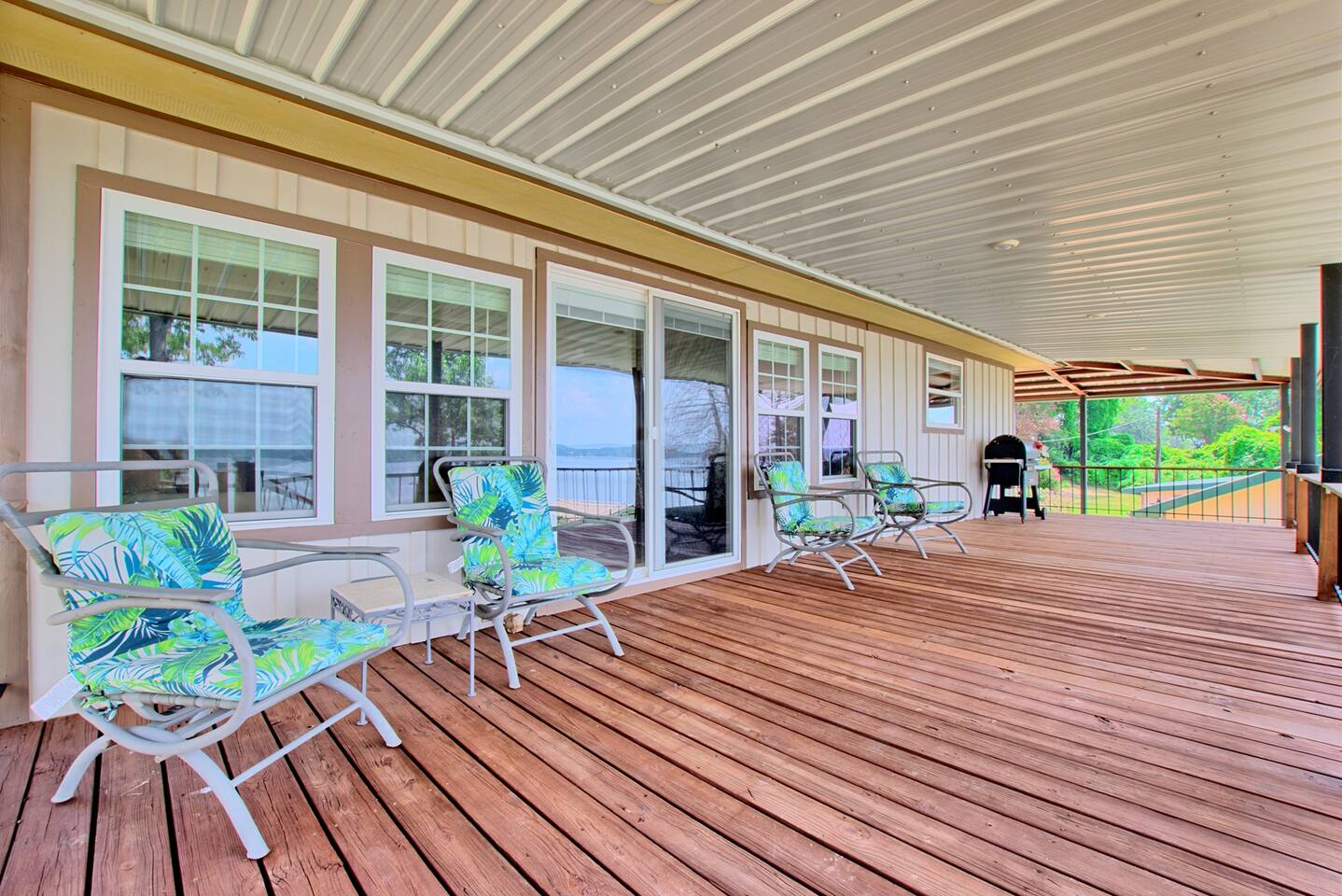 Covered back deck of the lake house with patio chairs