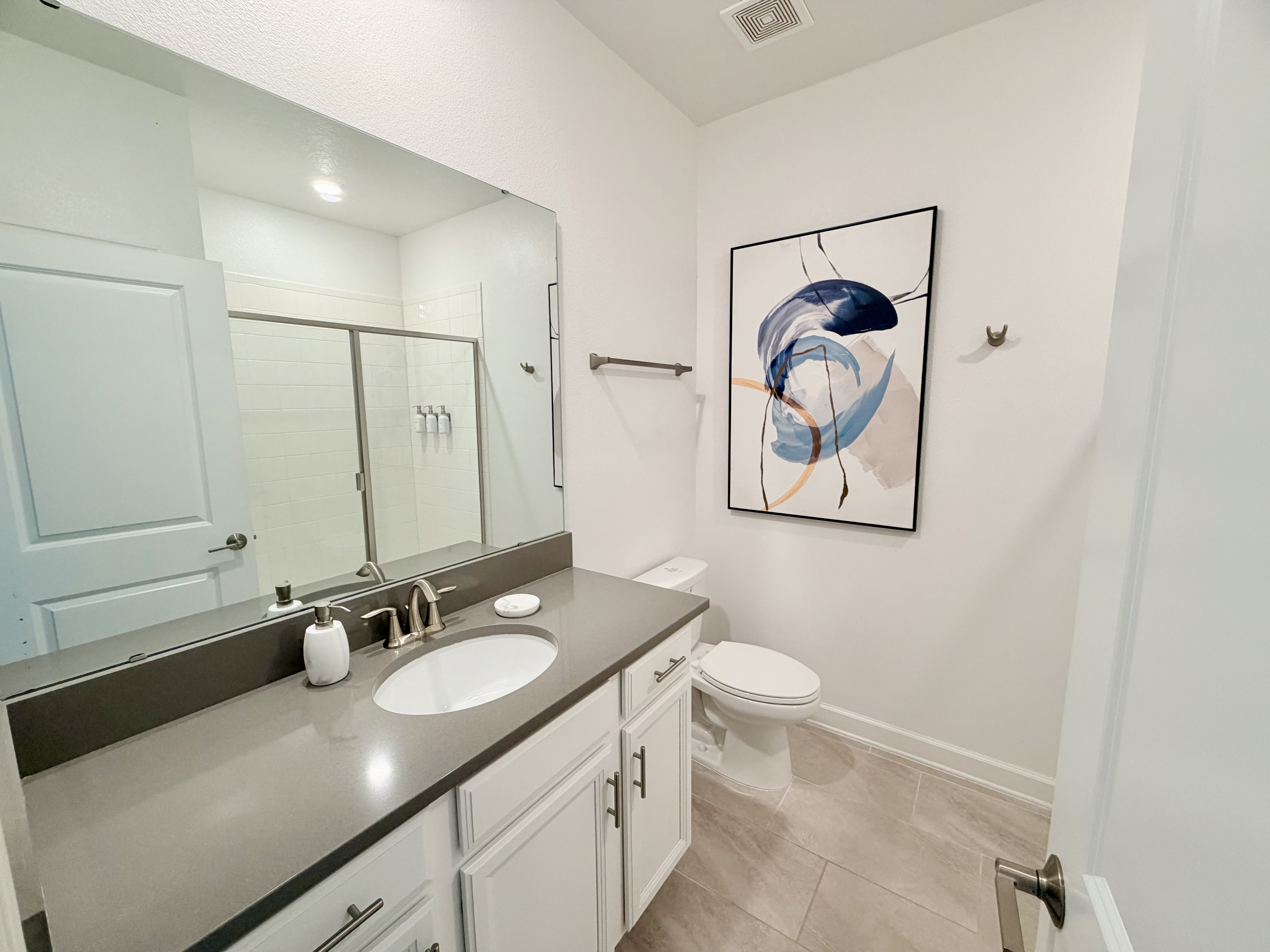 Bright modern bathroom with spacious vanity and glass shower