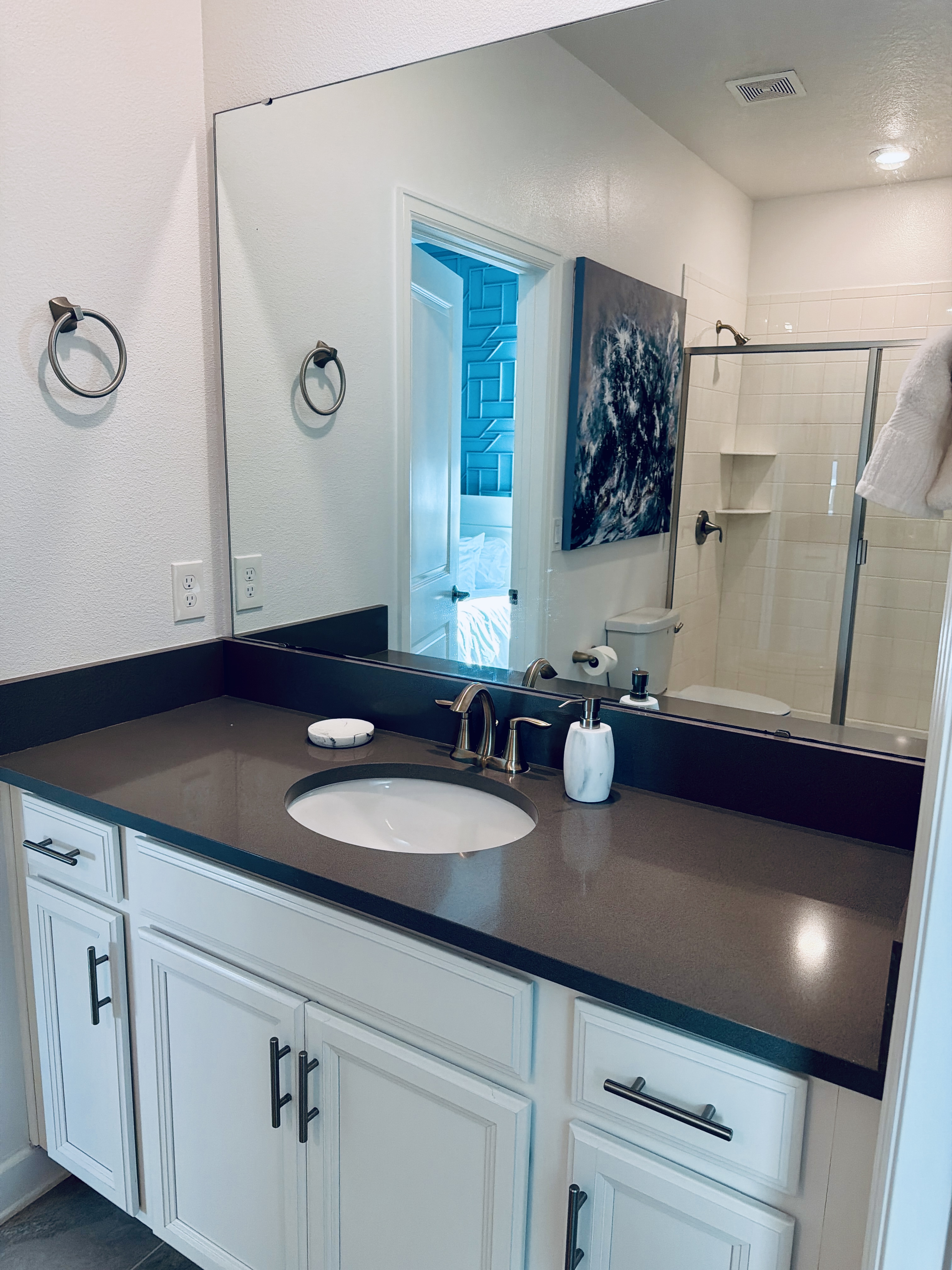 Bright modern bathroom with sleek vanity and glass walk-in shower