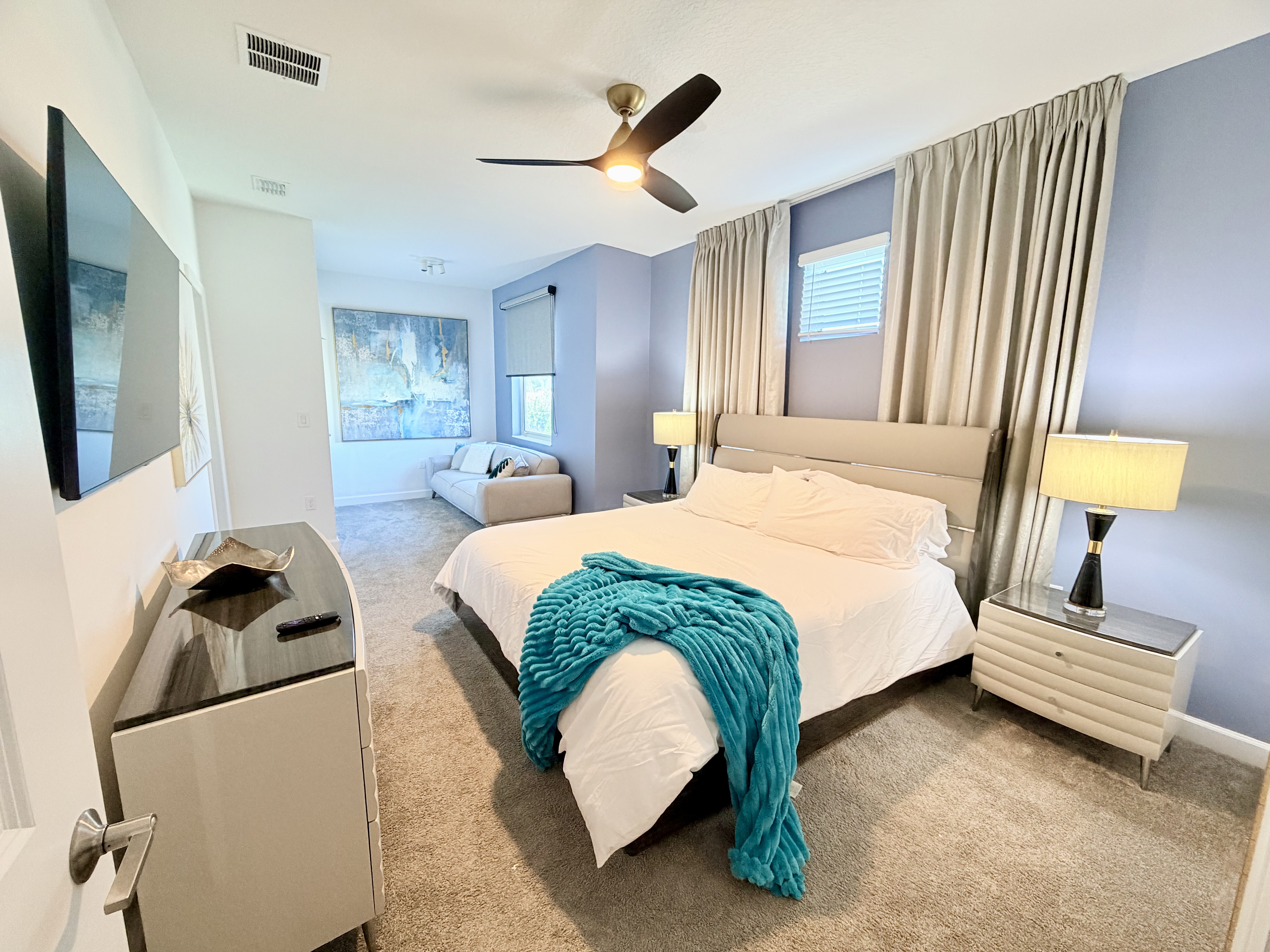 Spacious king bedroom with cozy sitting area and modern touches