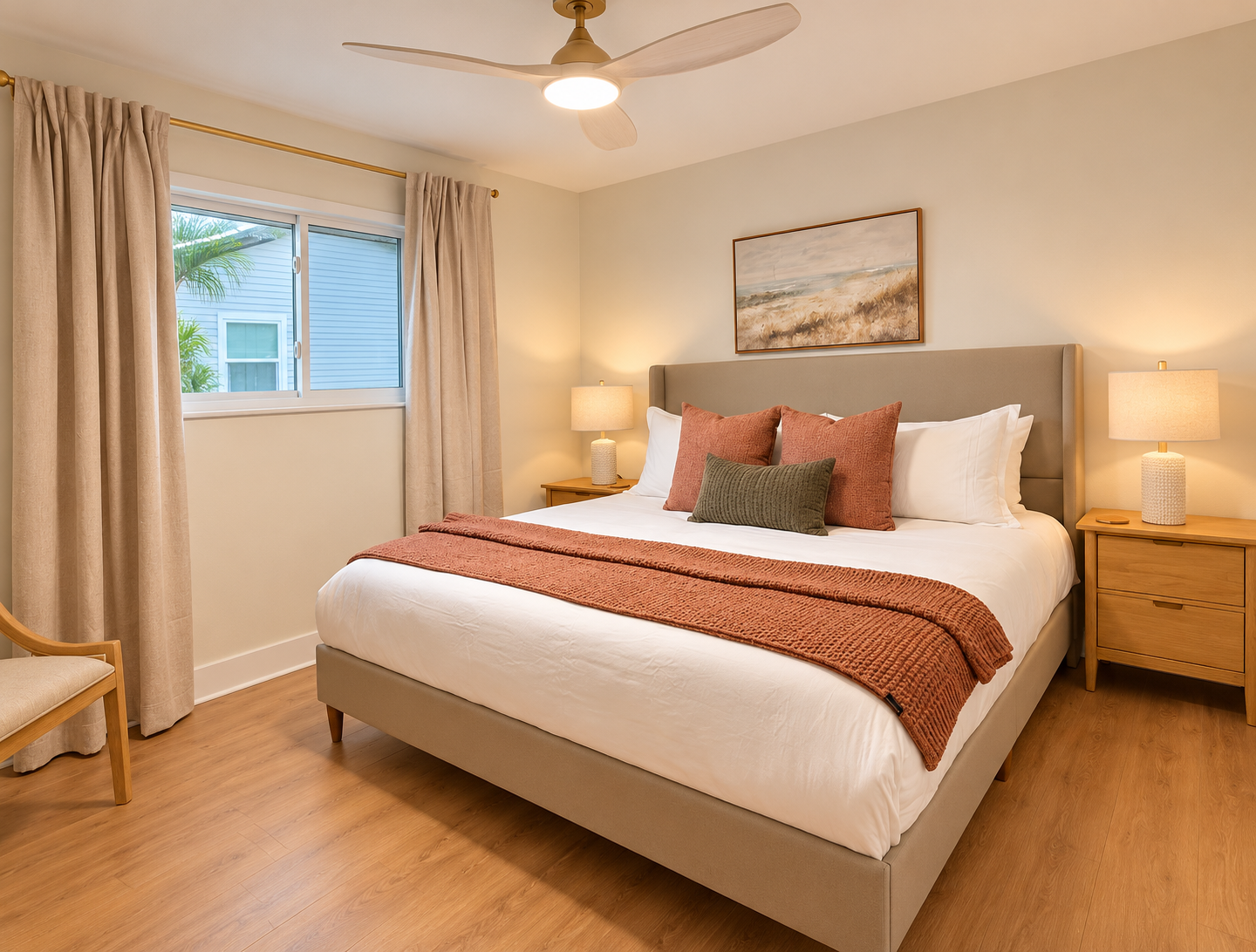 Cozy, stylish bedroom with plush king bed, warm lighting, and ceiling fan