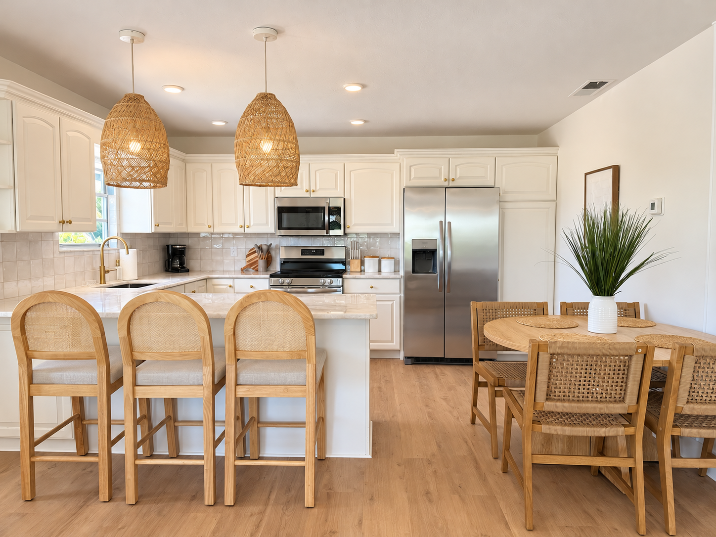 Bright coastal kitchen with island seating and charming dining nook