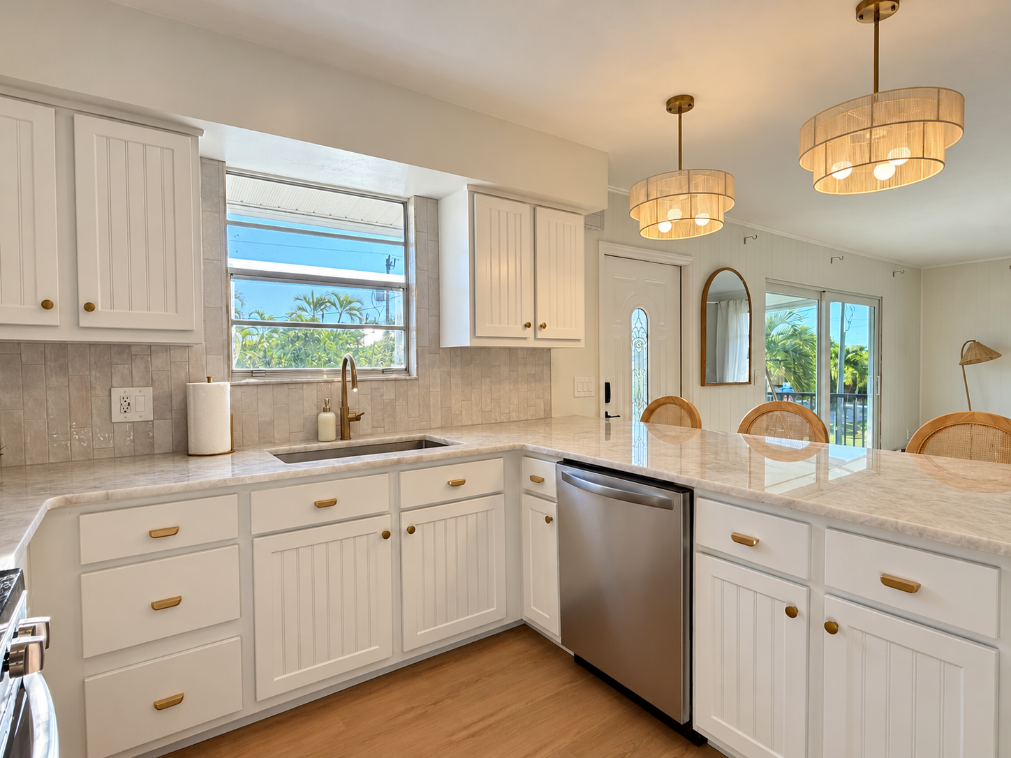Bright coastal kitchen with peninsula seating and modern finishes