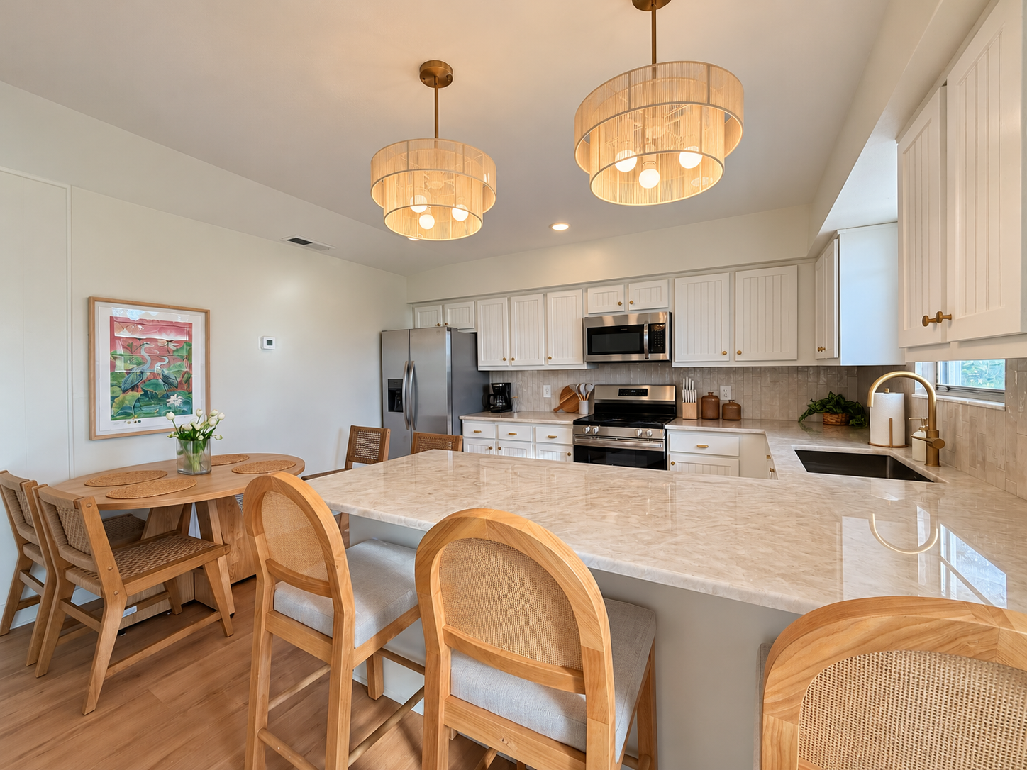 Bright designer kitchen with large island seating and cozy dining nook