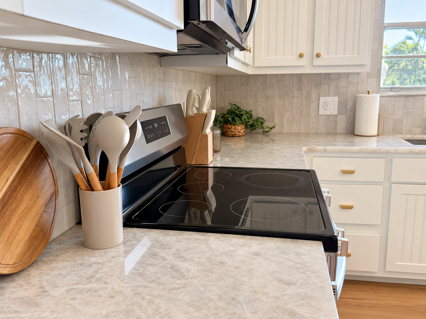 Bright updated kitchen with sleek cooktop and stylish finishes