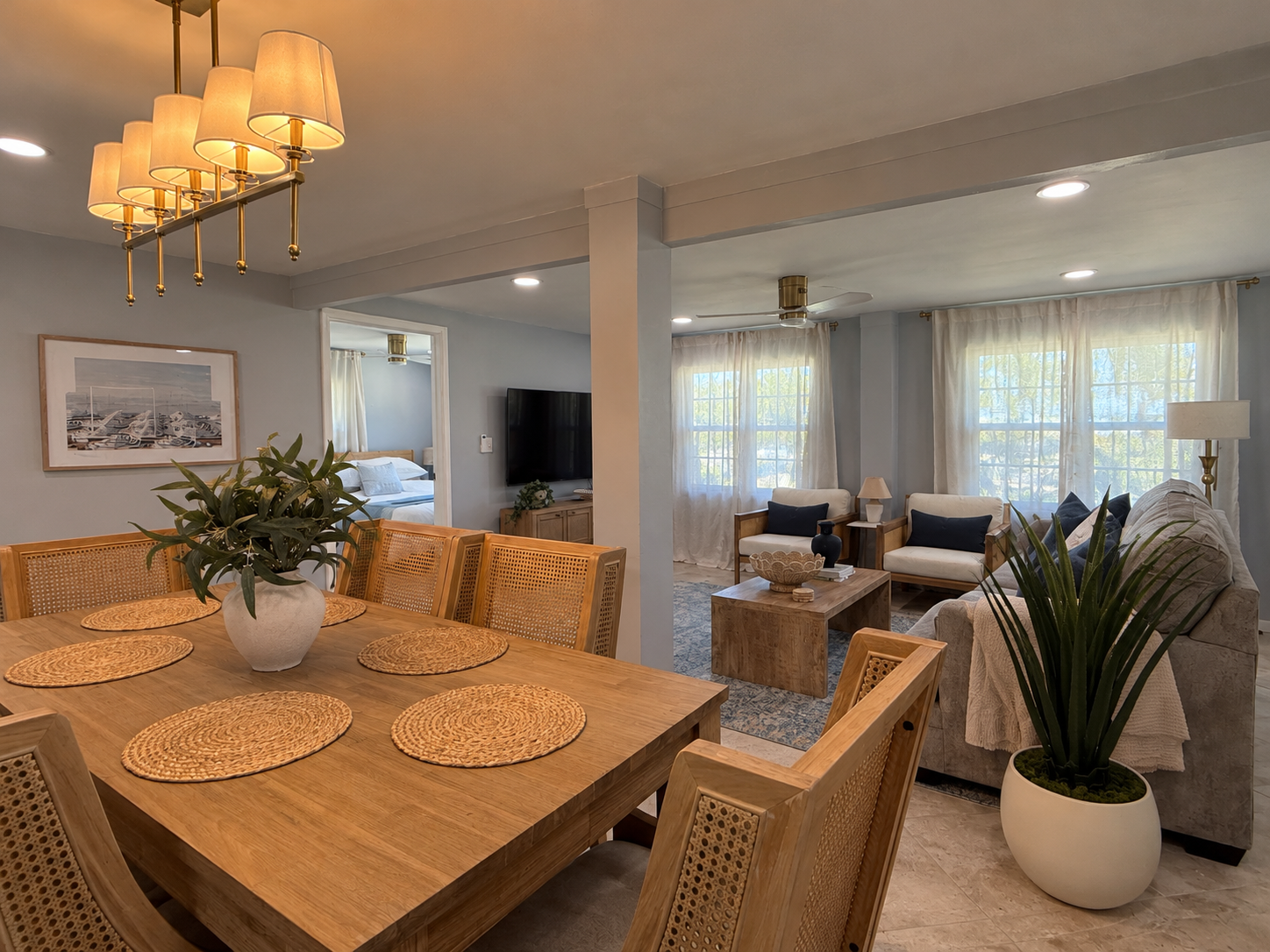 Bright open-concept dining and living space with stylish, cozy seating for 6 at table. 4 at island.