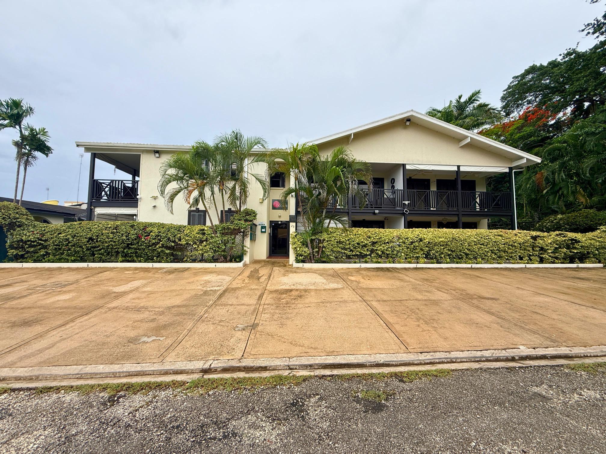 Tropical retreat with palm-lined entry, spacious lanais, and great curb appeal