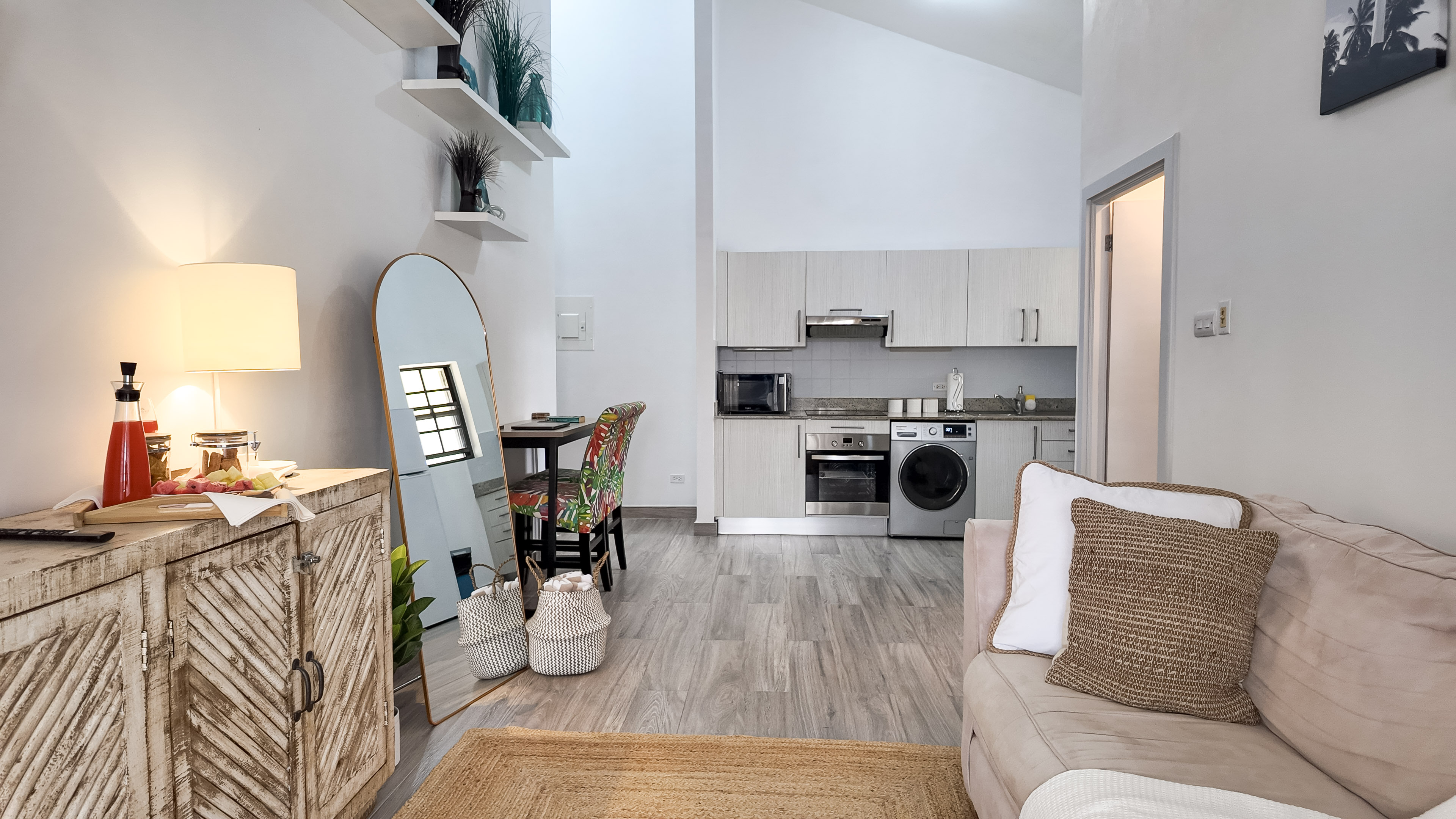 Bright open-plan studio with kitchenette, dining nook, and cozy lounge