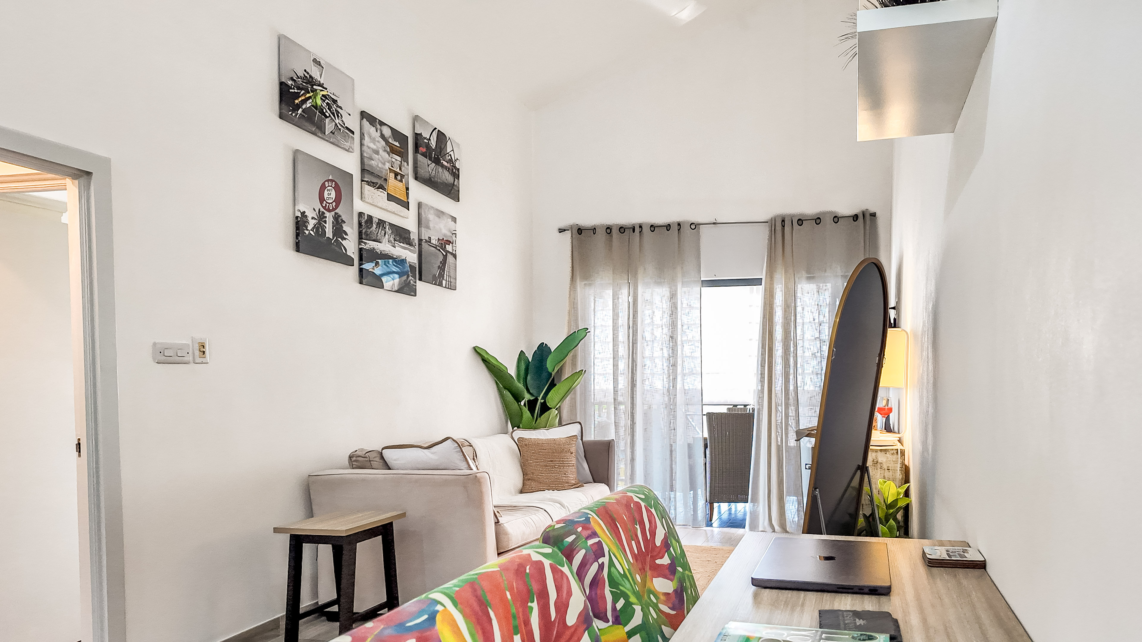 Bright loft-style lounge with balcony, workspace, and stylish decor