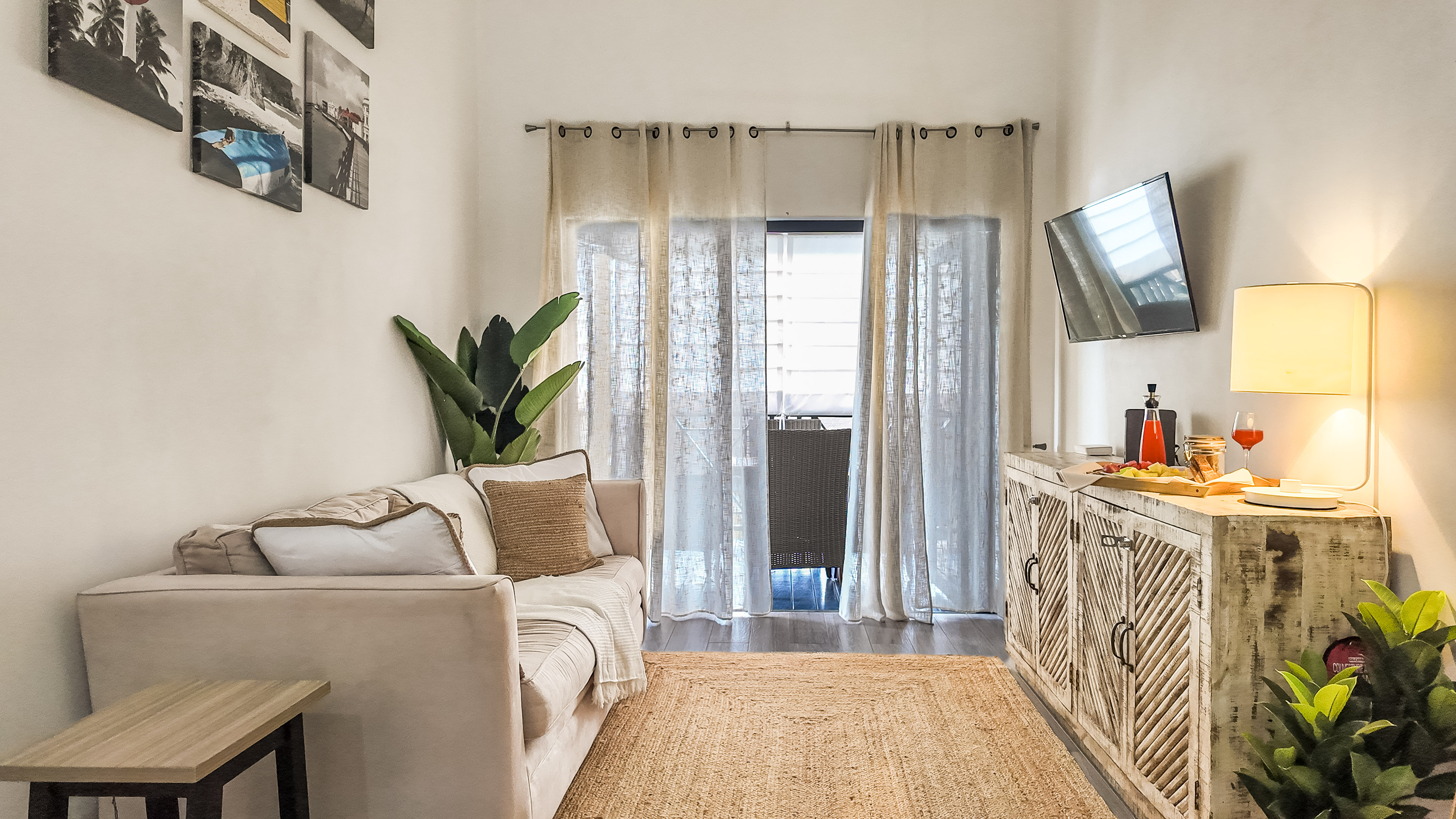 Bright, cozy lounge with balcony access, high ceilings, and stylish decor